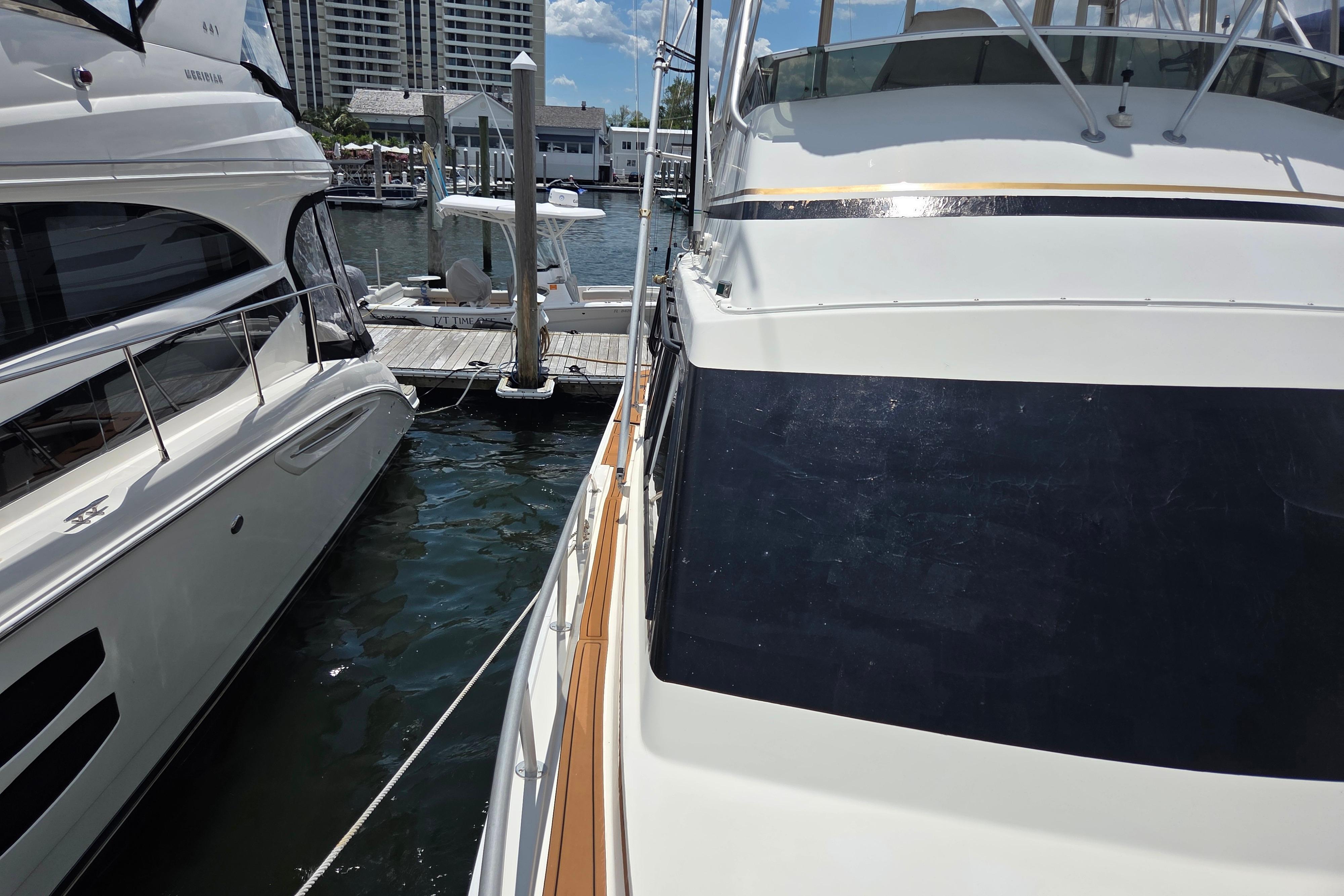 Docked Egg Harbor Golden Egg 42 yacht, 1990 model, beside another boat in a marina.