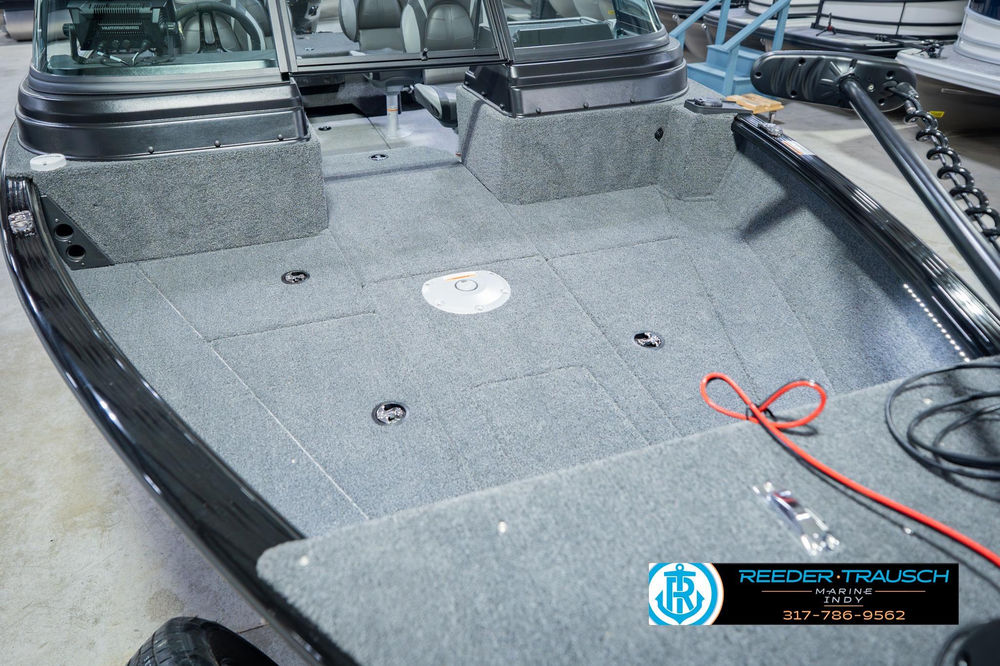 2026 Lund 1775 Impact XS boat interior with gray carpet and seating area.