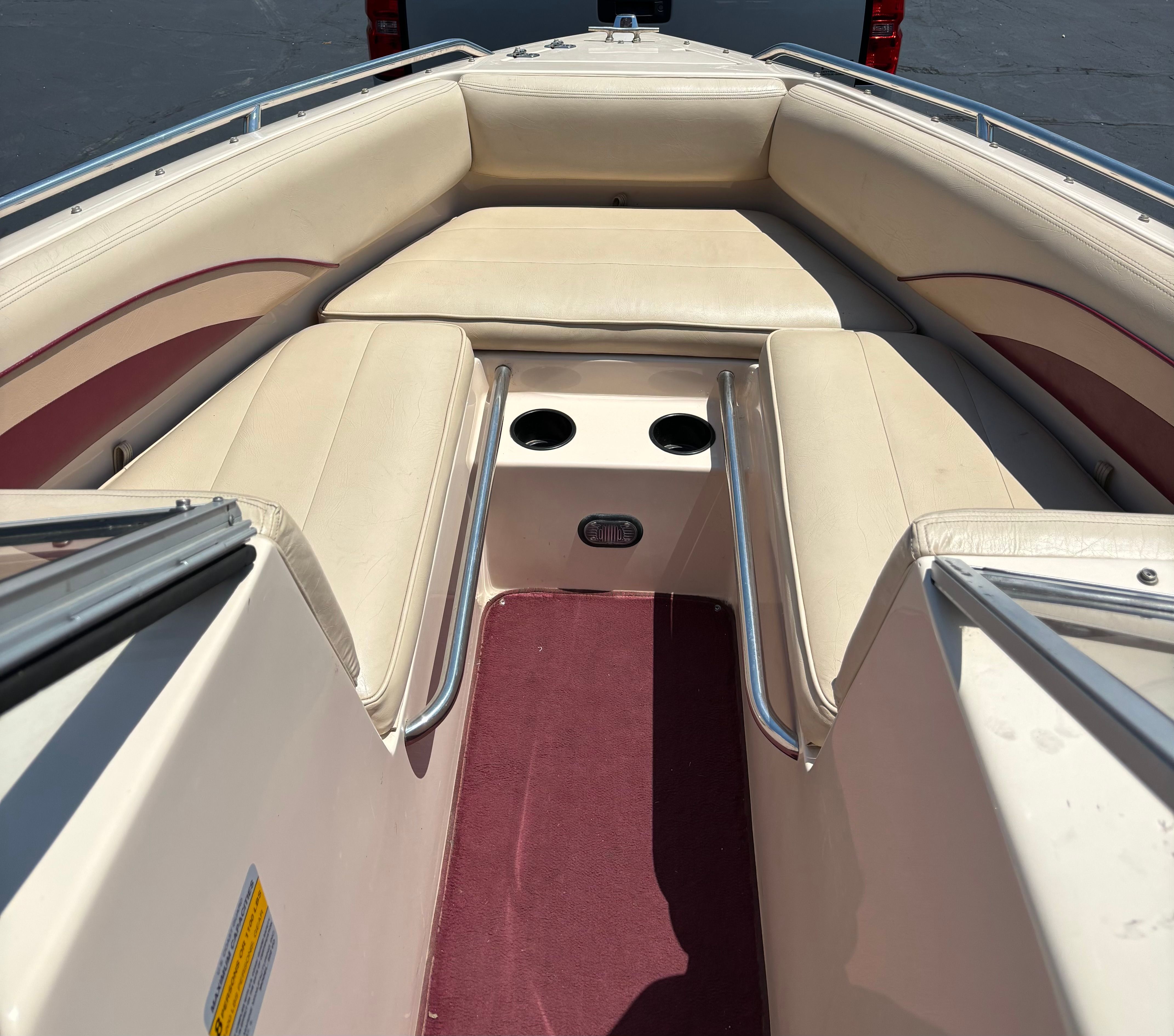 Interior of a 1996 Conquest 2100 boat with beige seating.