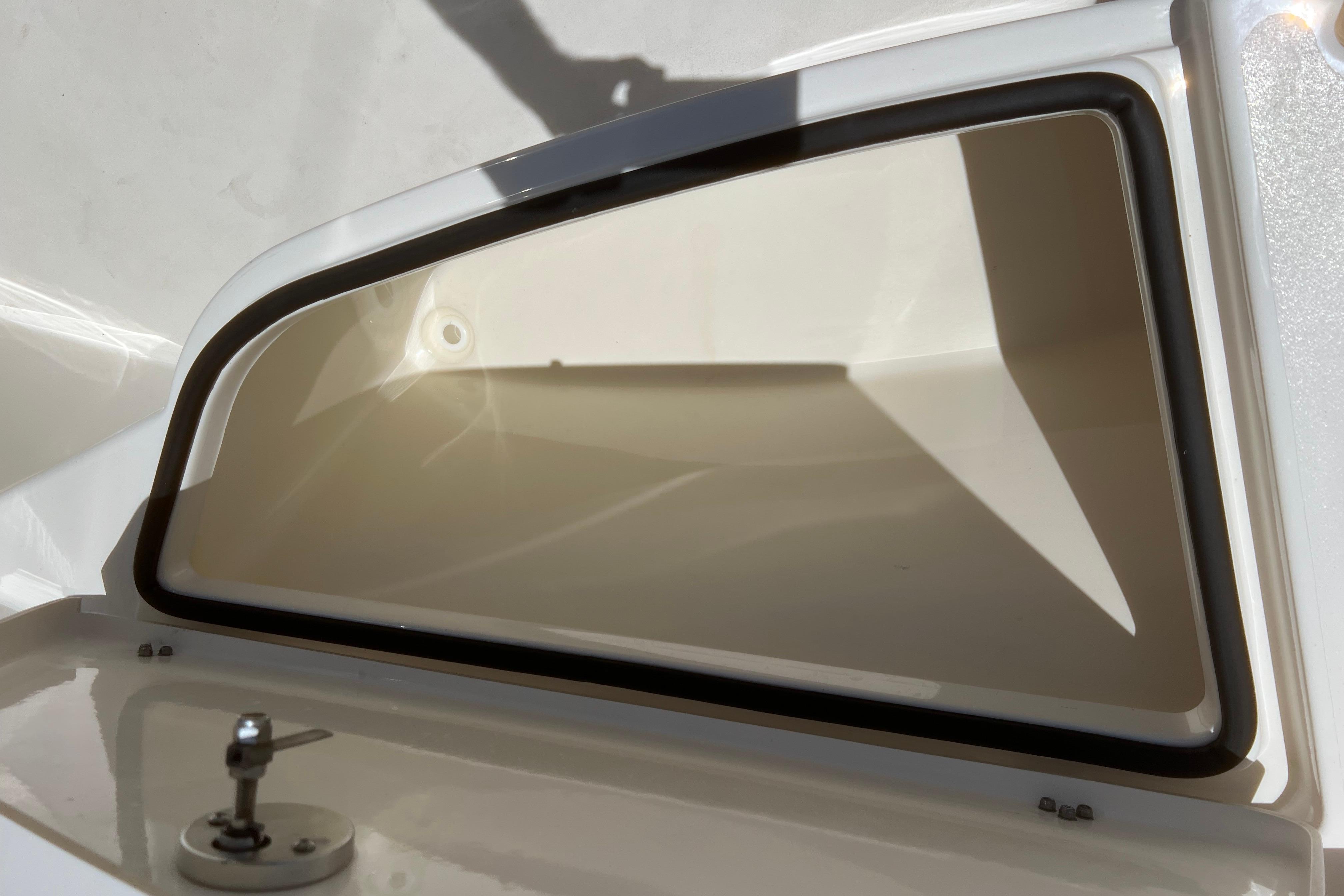Storage compartment of a 2018 Cobia 201 Center Console boat, open and empty.