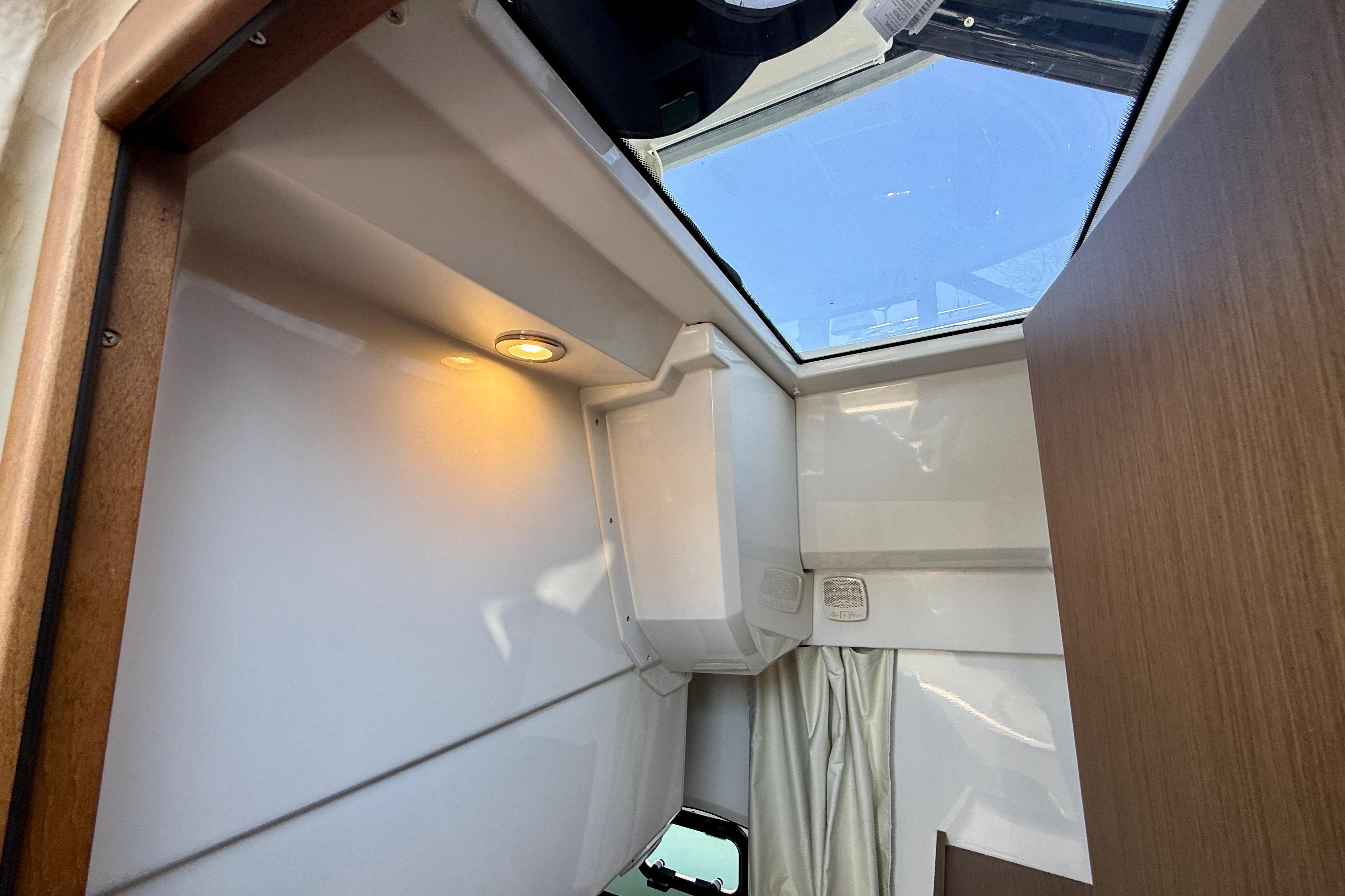 Interior view of 2022 Jeanneau NC 1095 Fly with skylight and modern lighting.
