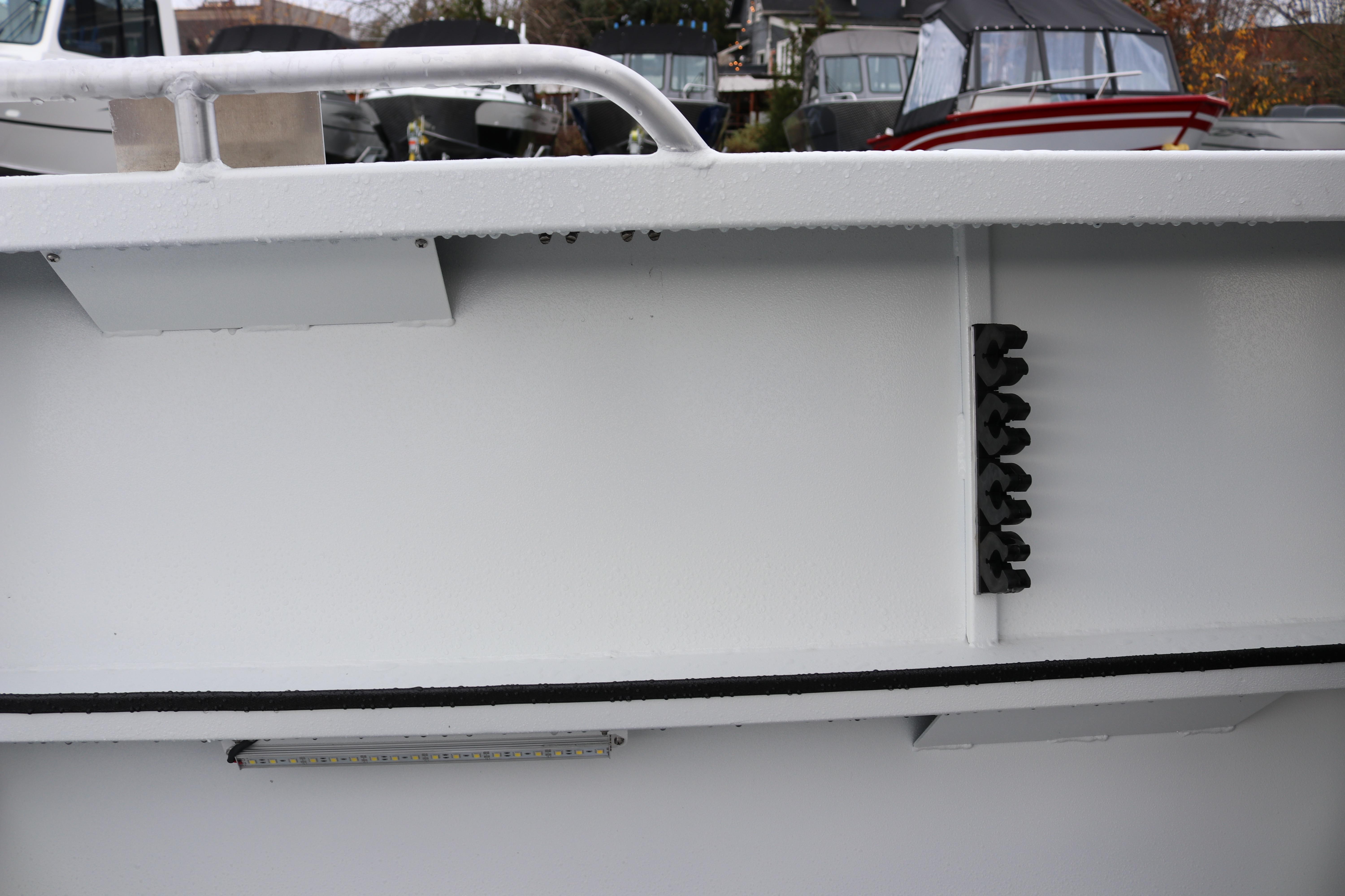 2026 Alumaweld Stryker 202 boat detail with railing and docked background.