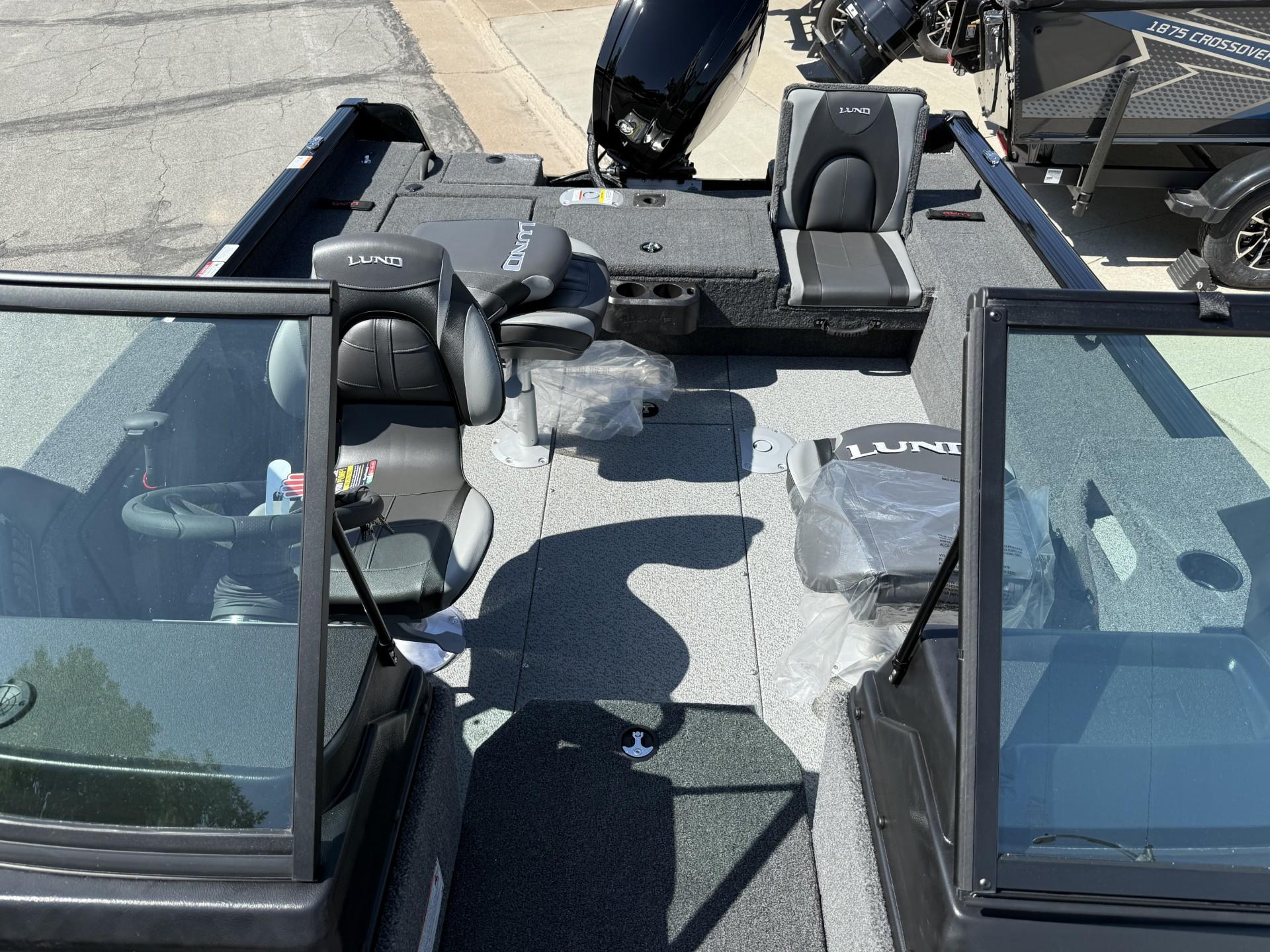 2025 Lund 1775 Impact XS boat interior with seating and windshield, showcasing modern design.