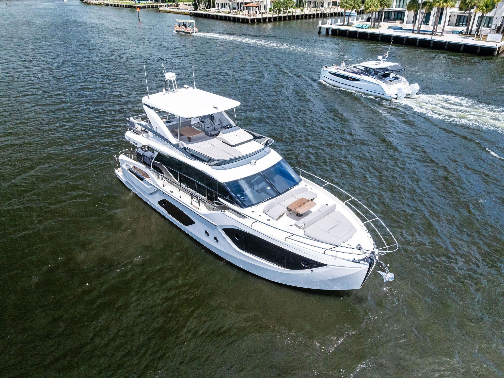 2023 Absolute 52 FLY yacht cruising on a sunny day in a scenic waterway.