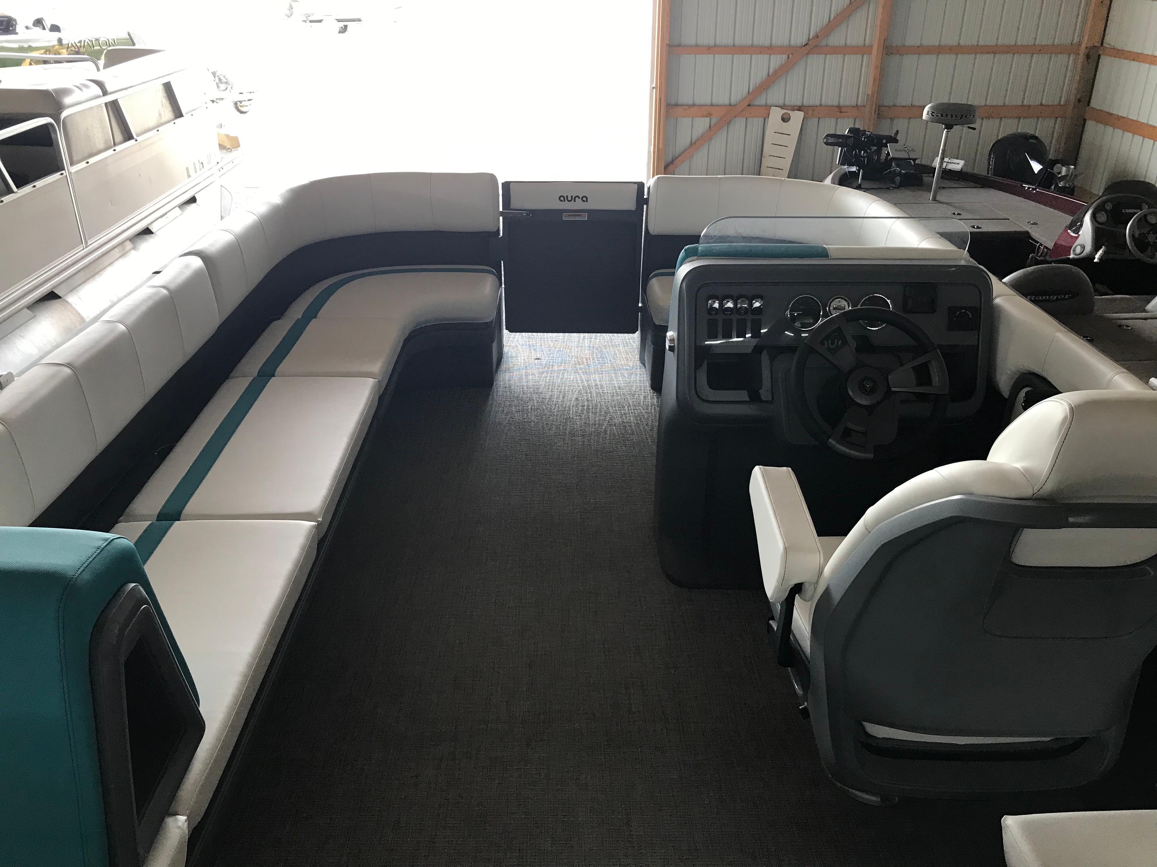 Interior of 2025 Avalon AURA boat with spacious seating and modern helm.