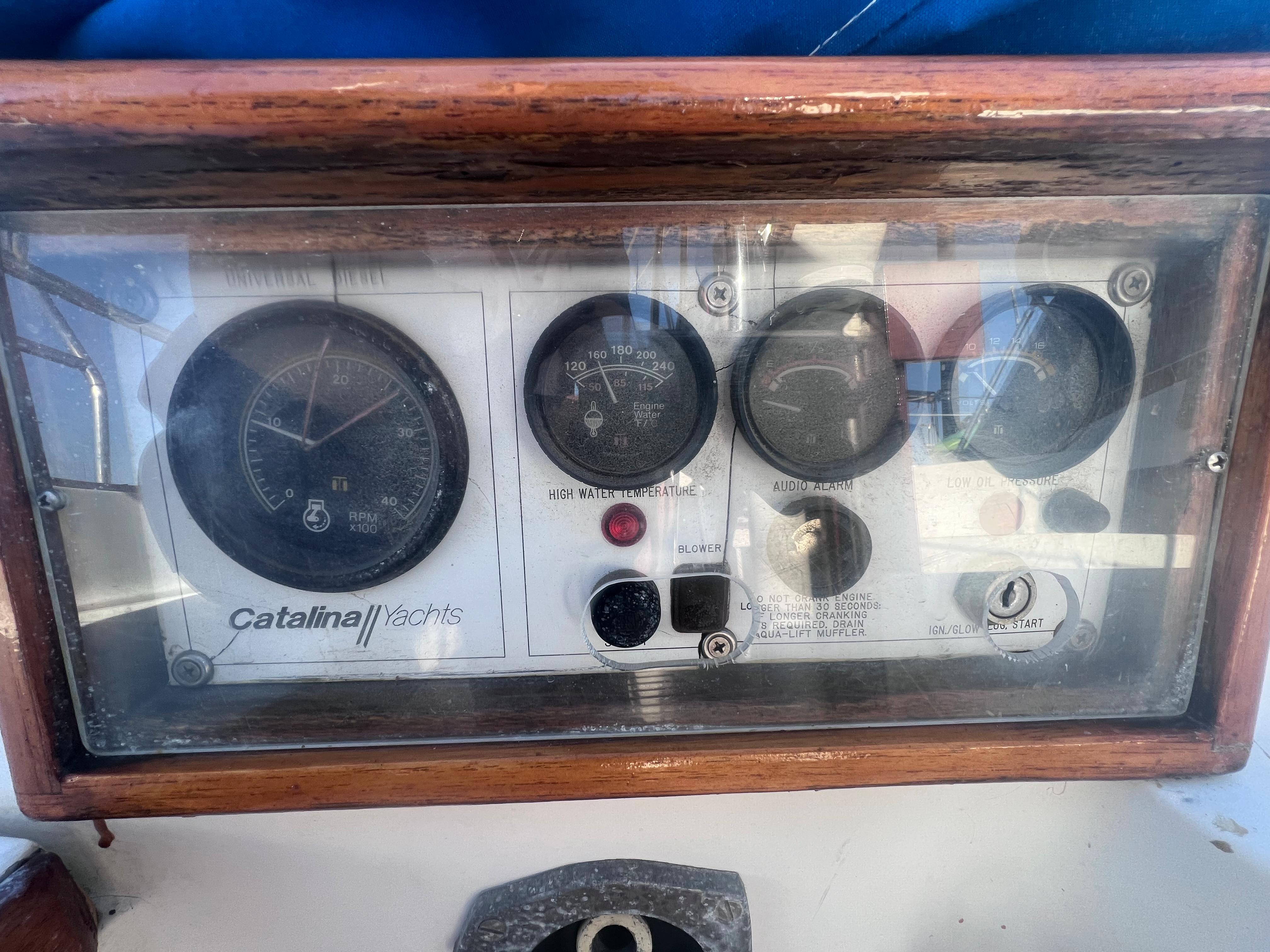 Control panel of a 1983 Catalina 36 yacht with gauges and indicators.