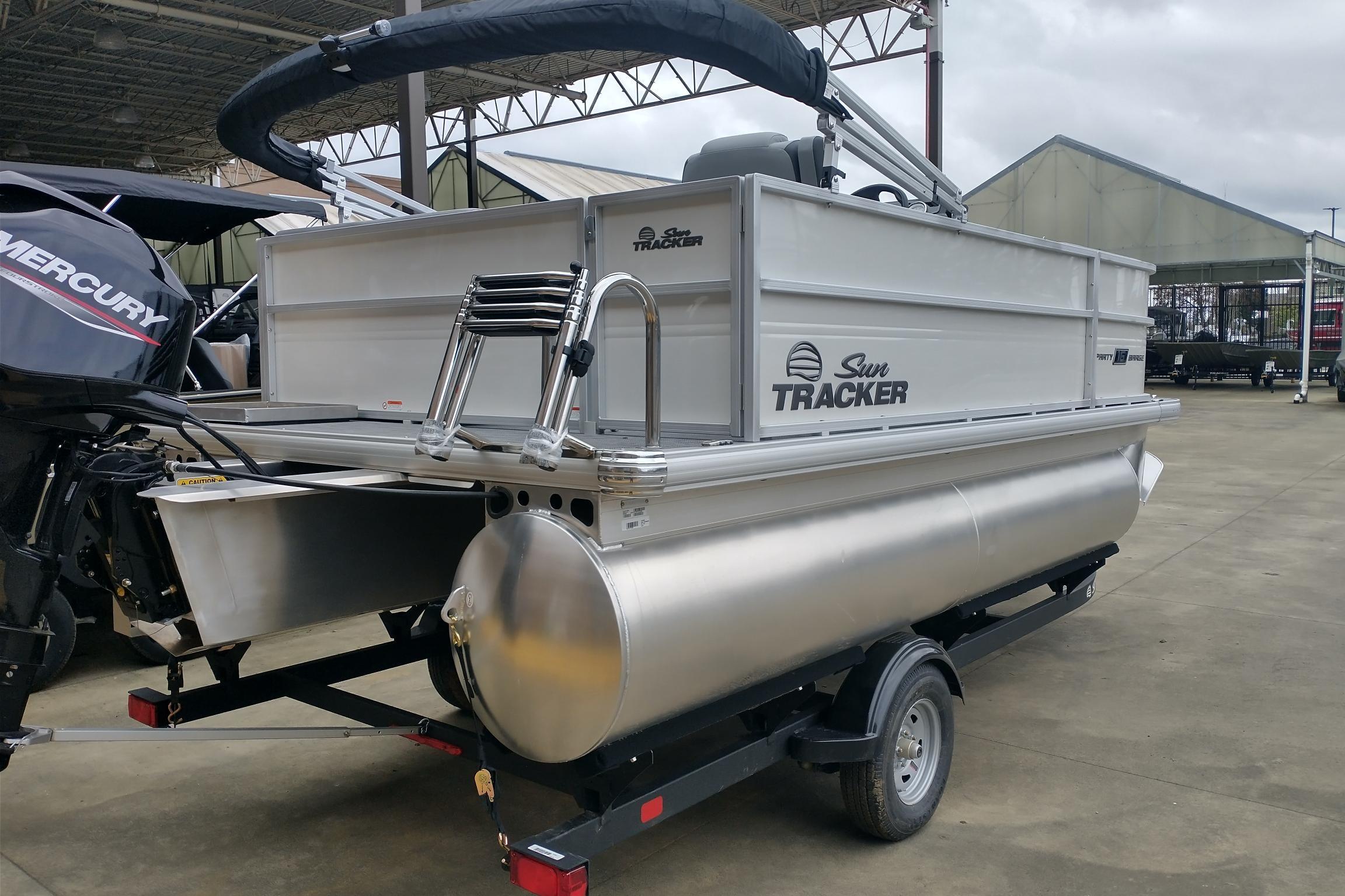 2026 Sun Tracker Party Barge 16 DLX pontoon boat on trailer, featuring Mercury outboard motor.