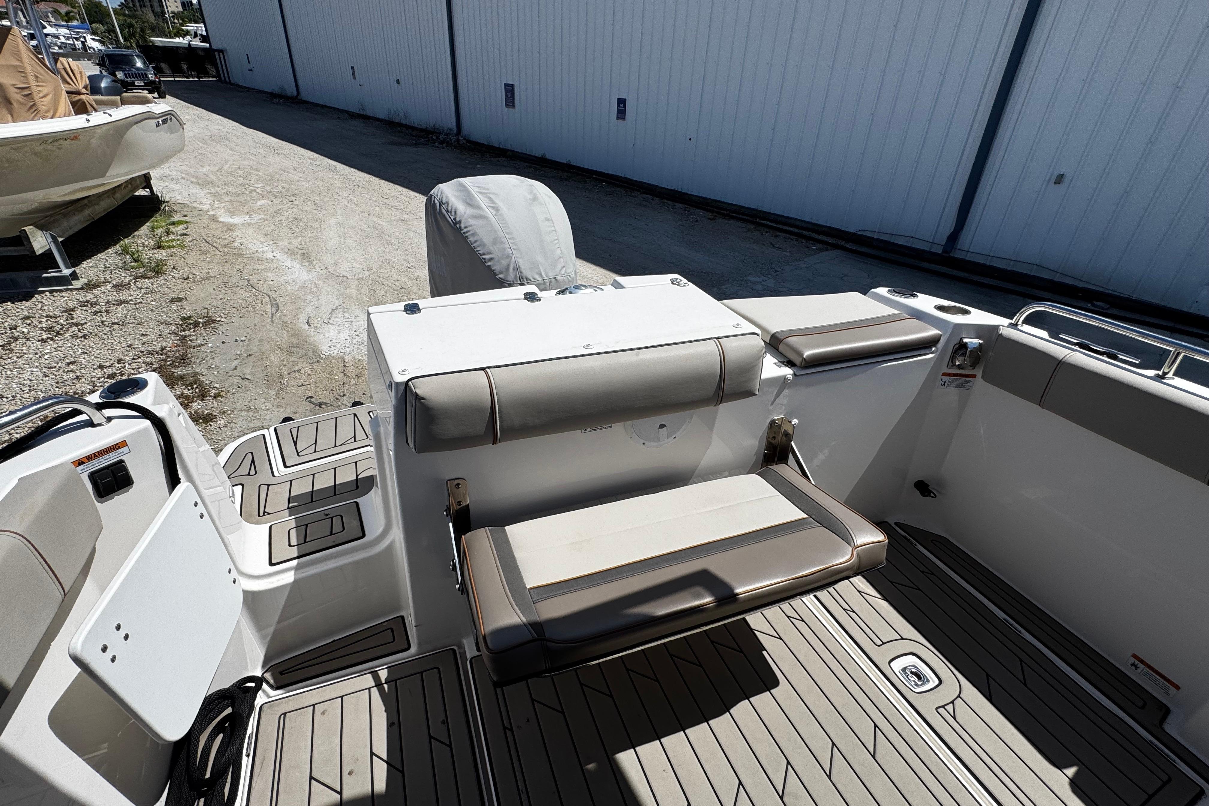 2022 Cutwater C-248 Coupe boat interior with cushioned seating and deck view.