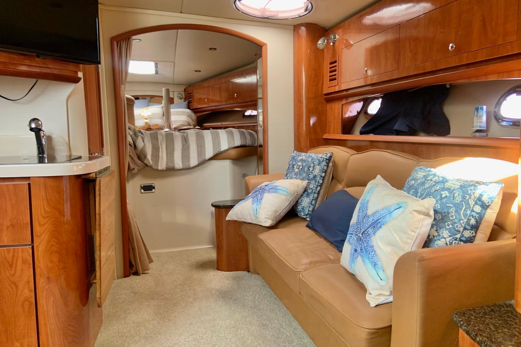 Interior of 2006 Four Winns 378 Vista yacht with cozy seating and elegant wood finishes.