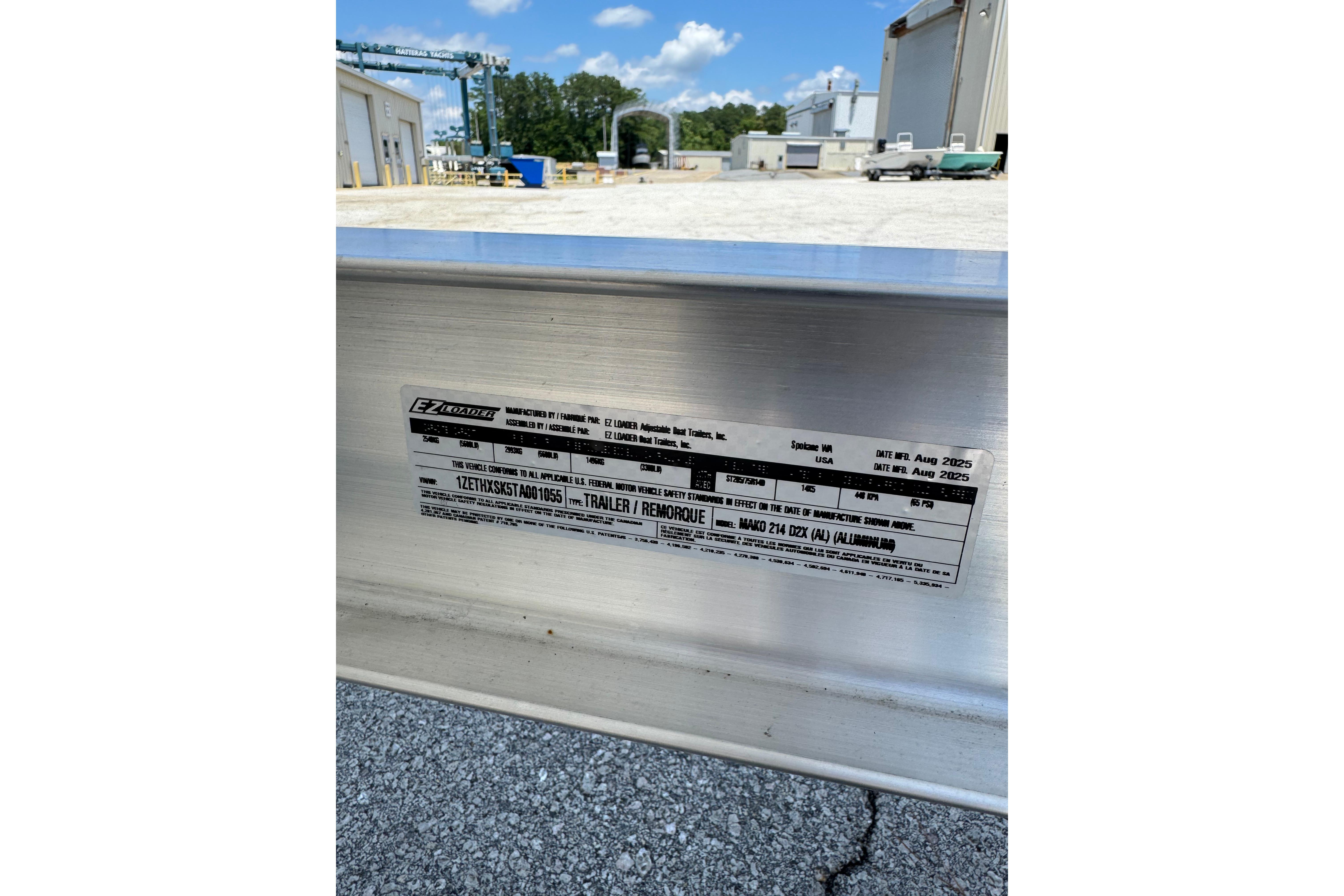 Label on aluminum trailer for Mako 214 Center Console, 2026 model, in industrial setting.