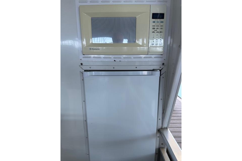 Microwave and fridge inside 2008 Destination Yachts 45X14 boat kitchen area.