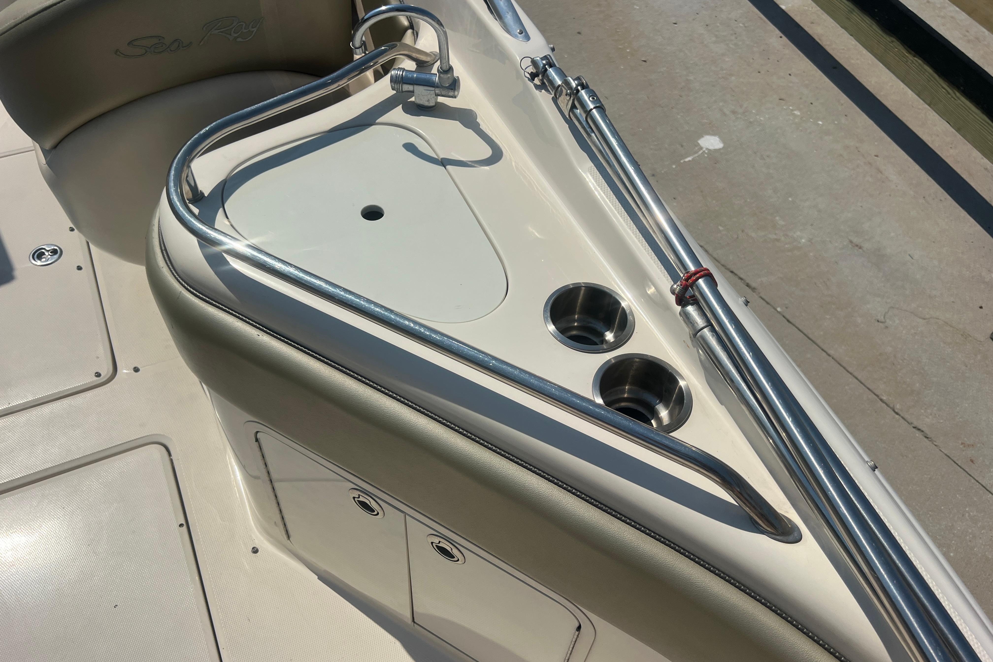 2005 Sea Ray 240 Sundeck boat interior with sink and cup holders.