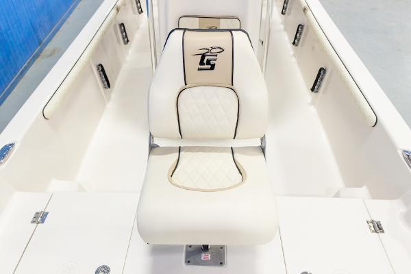 Manufacturer Provided Image: 2026 Carolina Skiff 23 LS boat interior with white cushioned seating and logo embroidery.