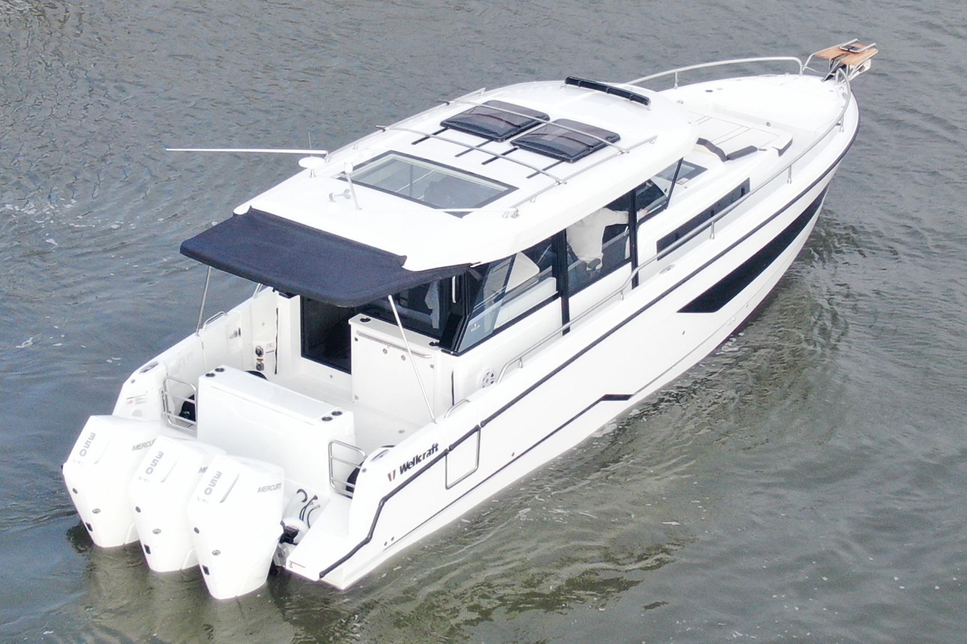 2026 Wellcraft 38 Explorer boat on water, featuring sleek design and triple outboard engines.