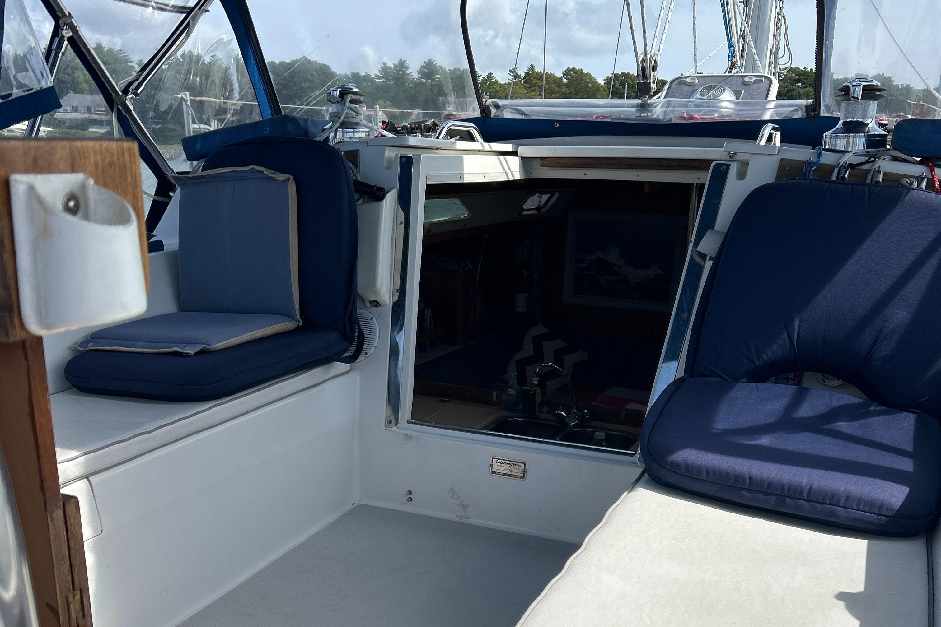 1998 Catalina 36MKII sailboat cockpit with blue cushions and open cabin entrance.
