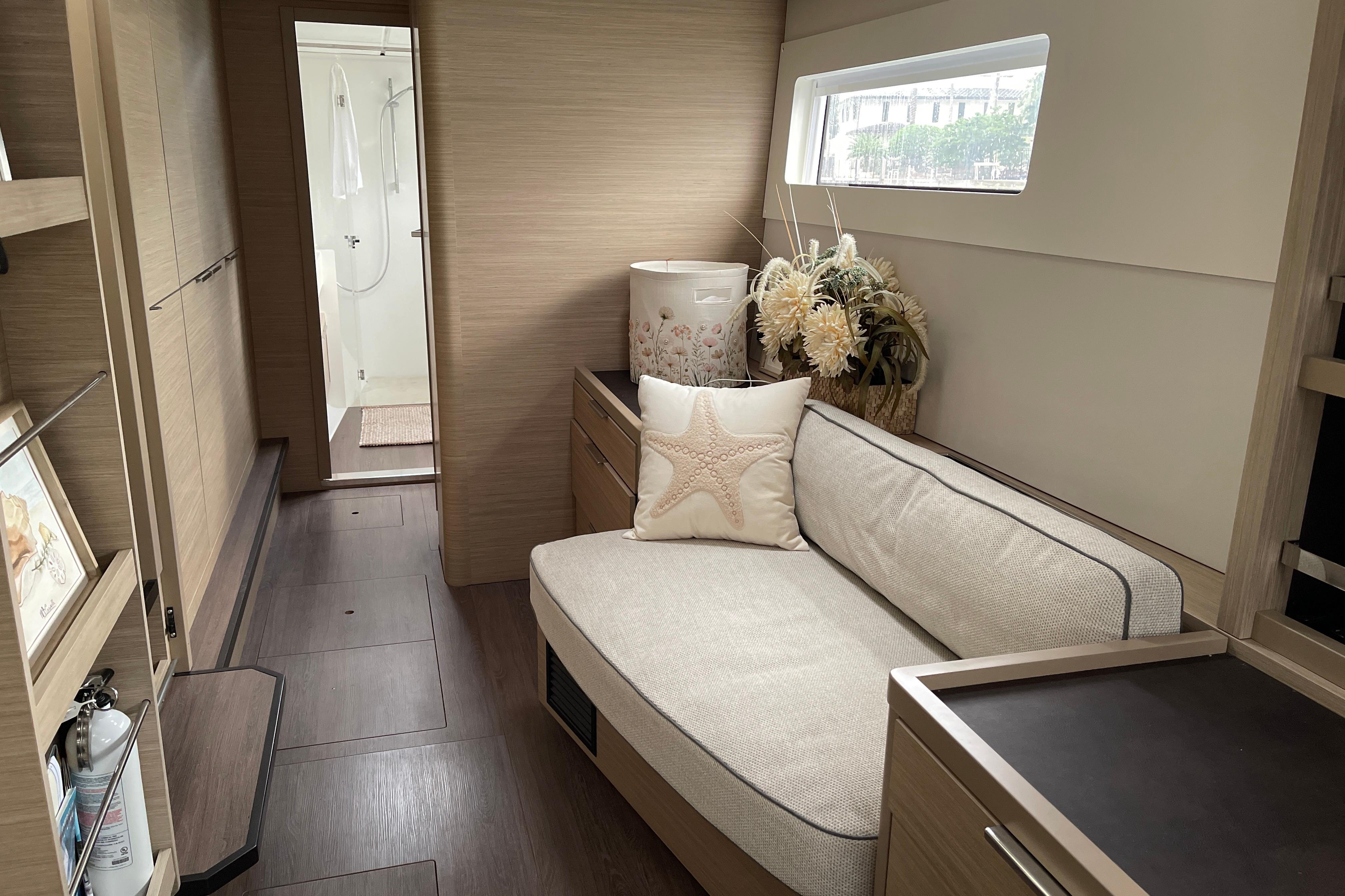 Luxurious interior of 2024 Lagoon 46 yacht with cozy seating and elegant decor.