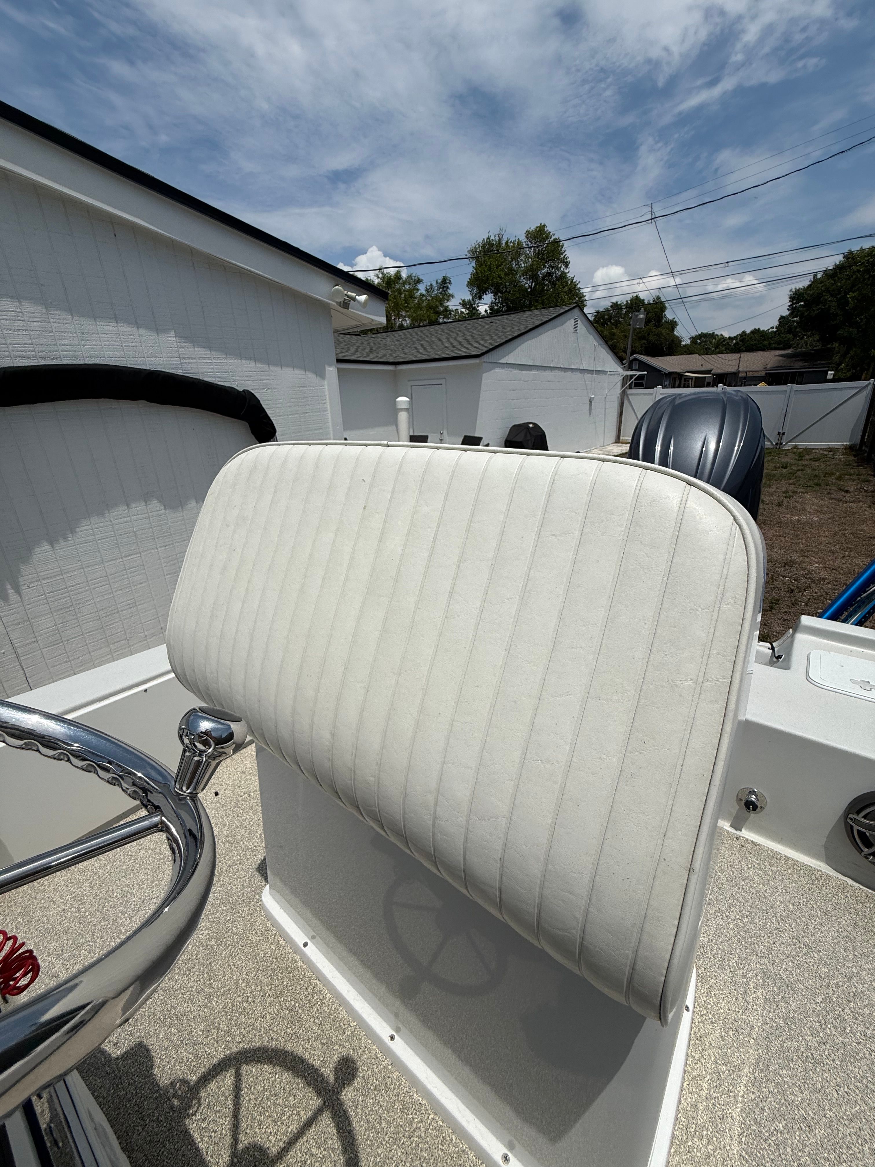 2012 Bay Craft 21 boat with white seat and steering wheel.