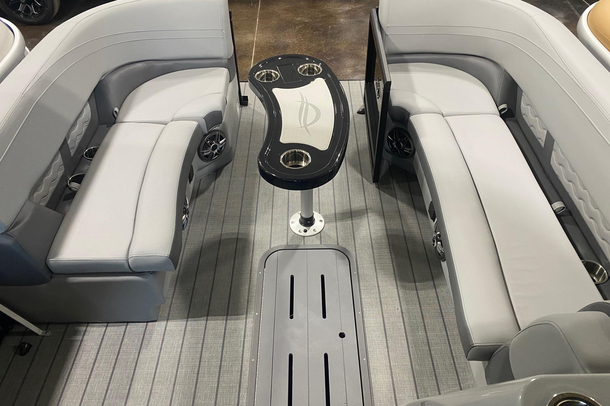 Luxurious interior of 2026 SunCatcher Fusion 324SS pontoon boat with sleek seating and table.