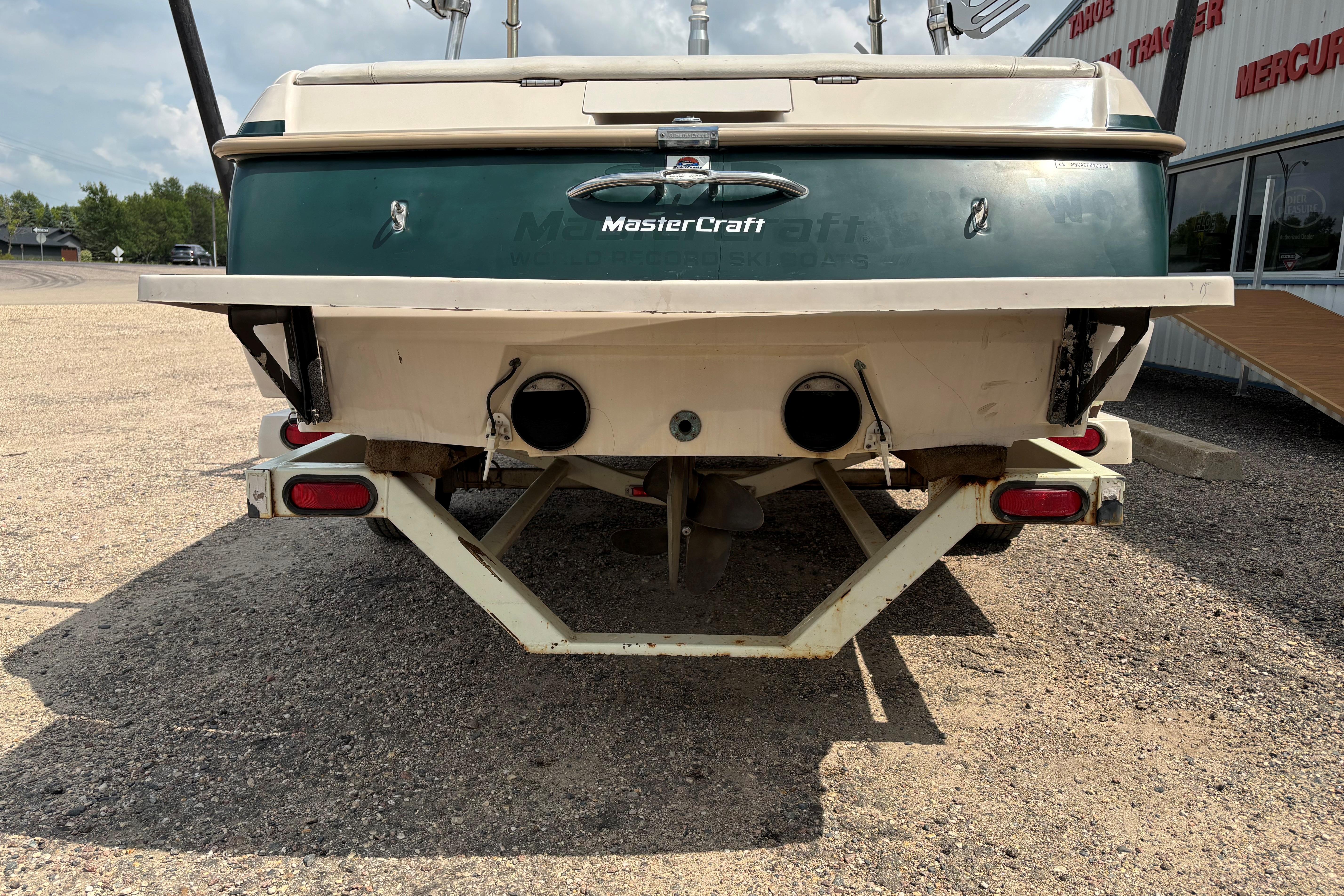Rear view of a 1999 MasterCraft 205 PRO STAR boat on a trailer.