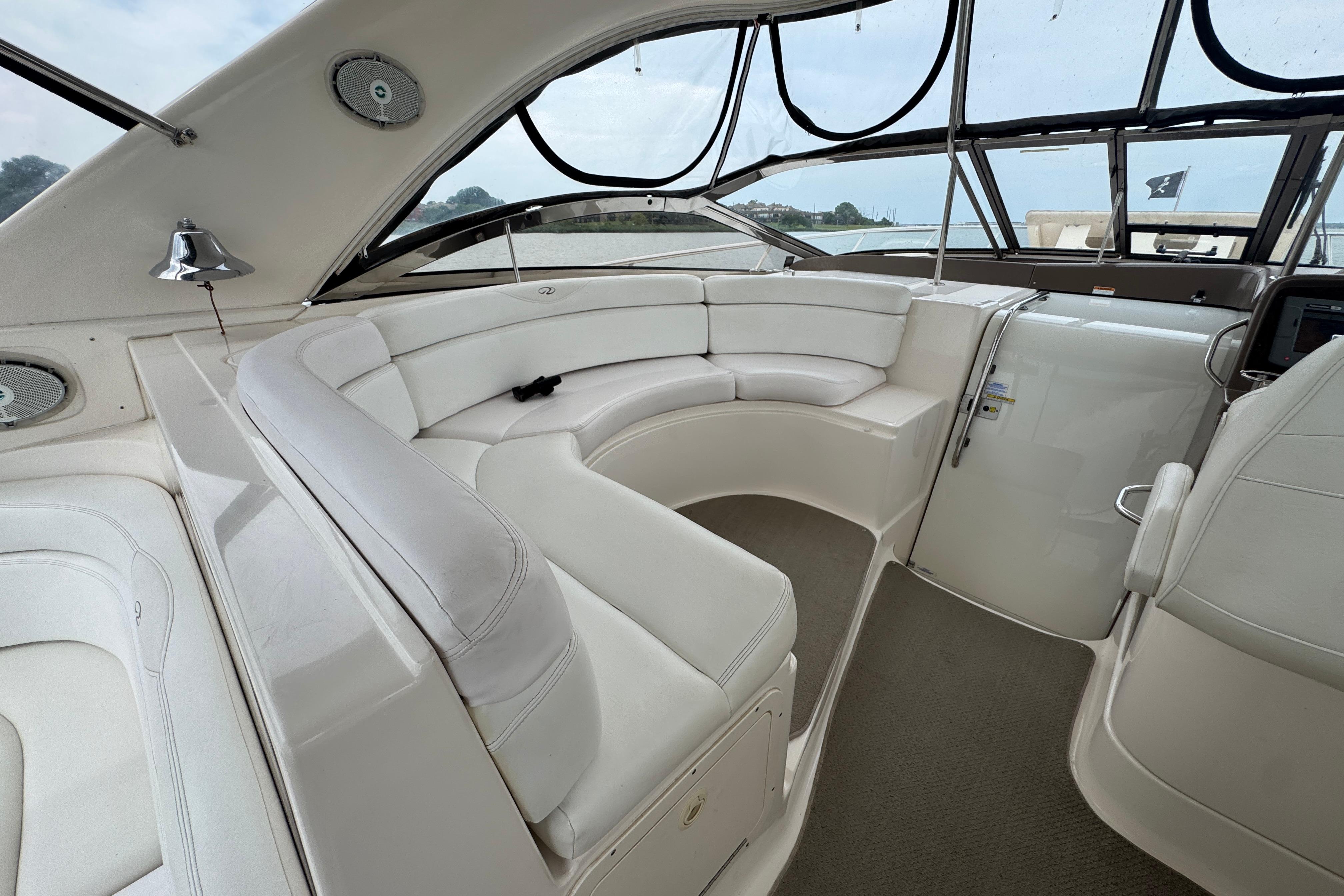 2005 Regal Commodore 4260 yacht interior with white leather seating and panoramic windows.