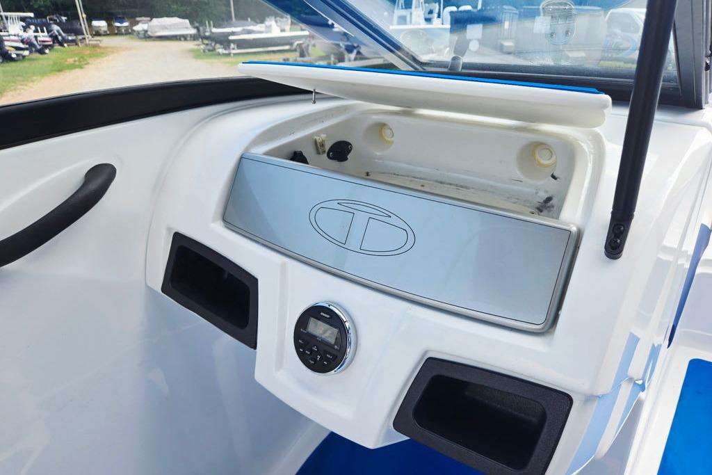 2018 Tahoe 450 TS boat dashboard with storage compartment and control panel.