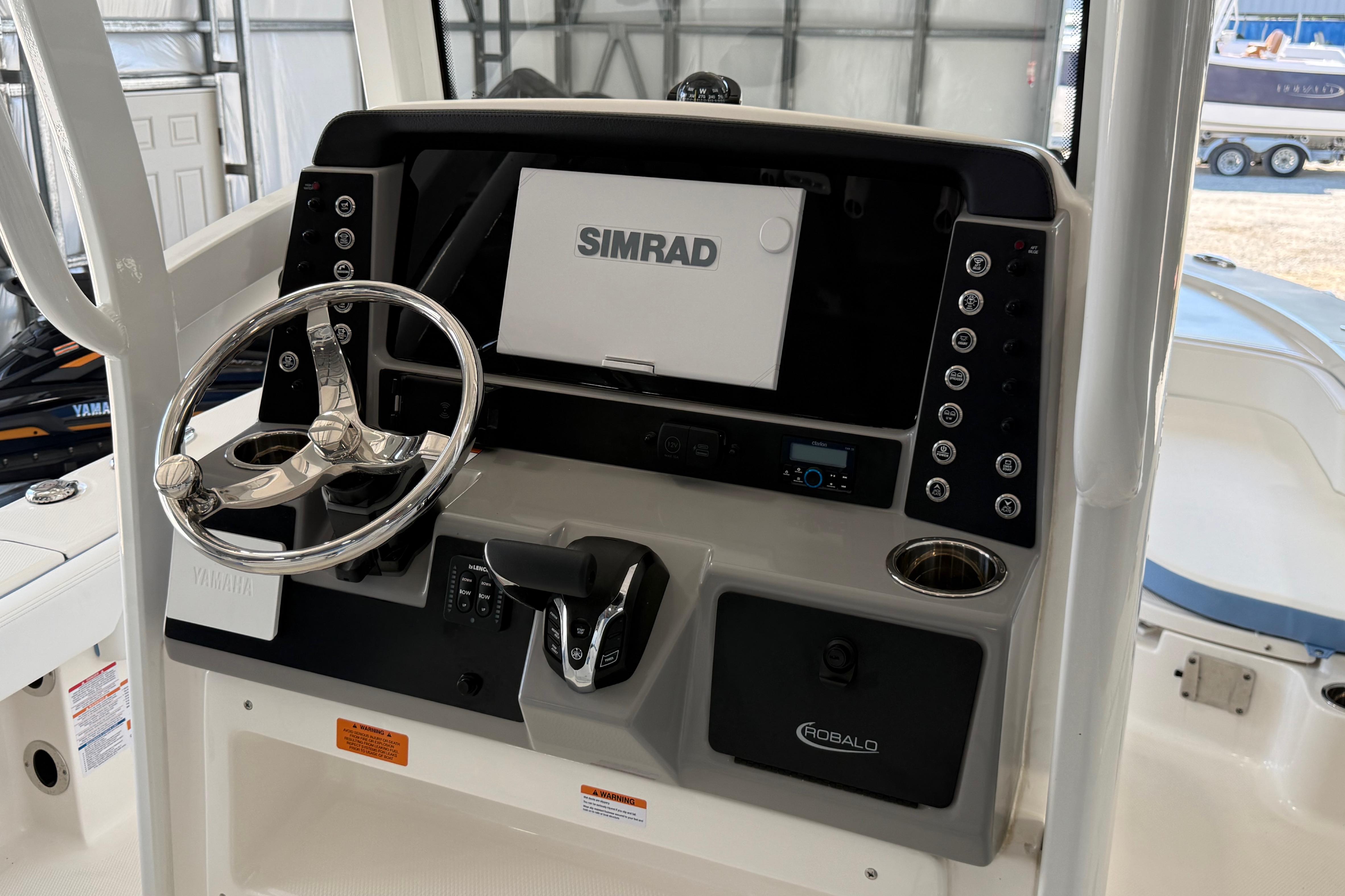 2026 Robalo 246 Cayman boat dashboard with Simrad display and steering wheel.