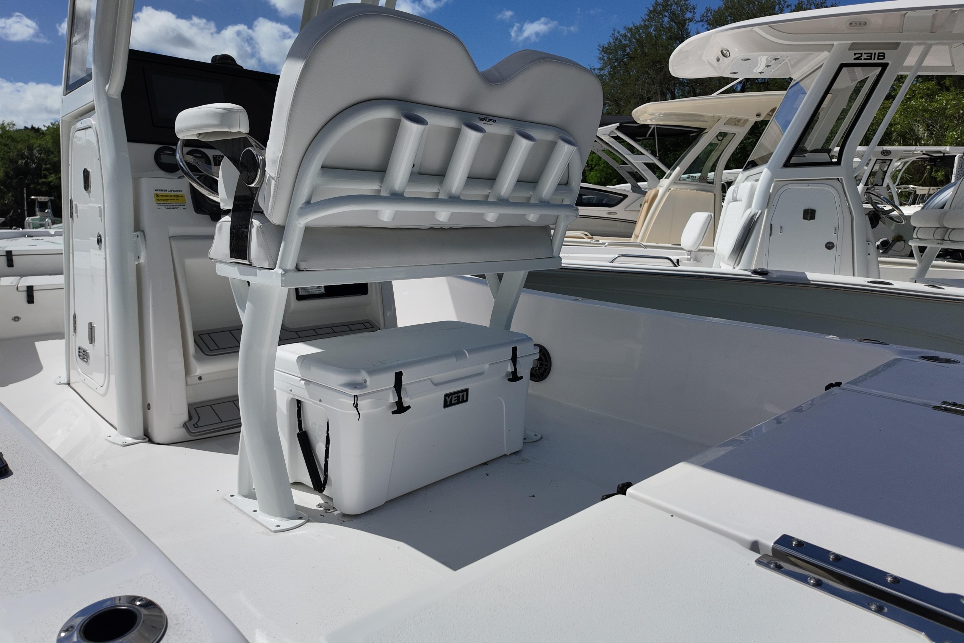 2026 Sea Fox 251 Bay Fox boat interior with seating and cooler under sunny skies.