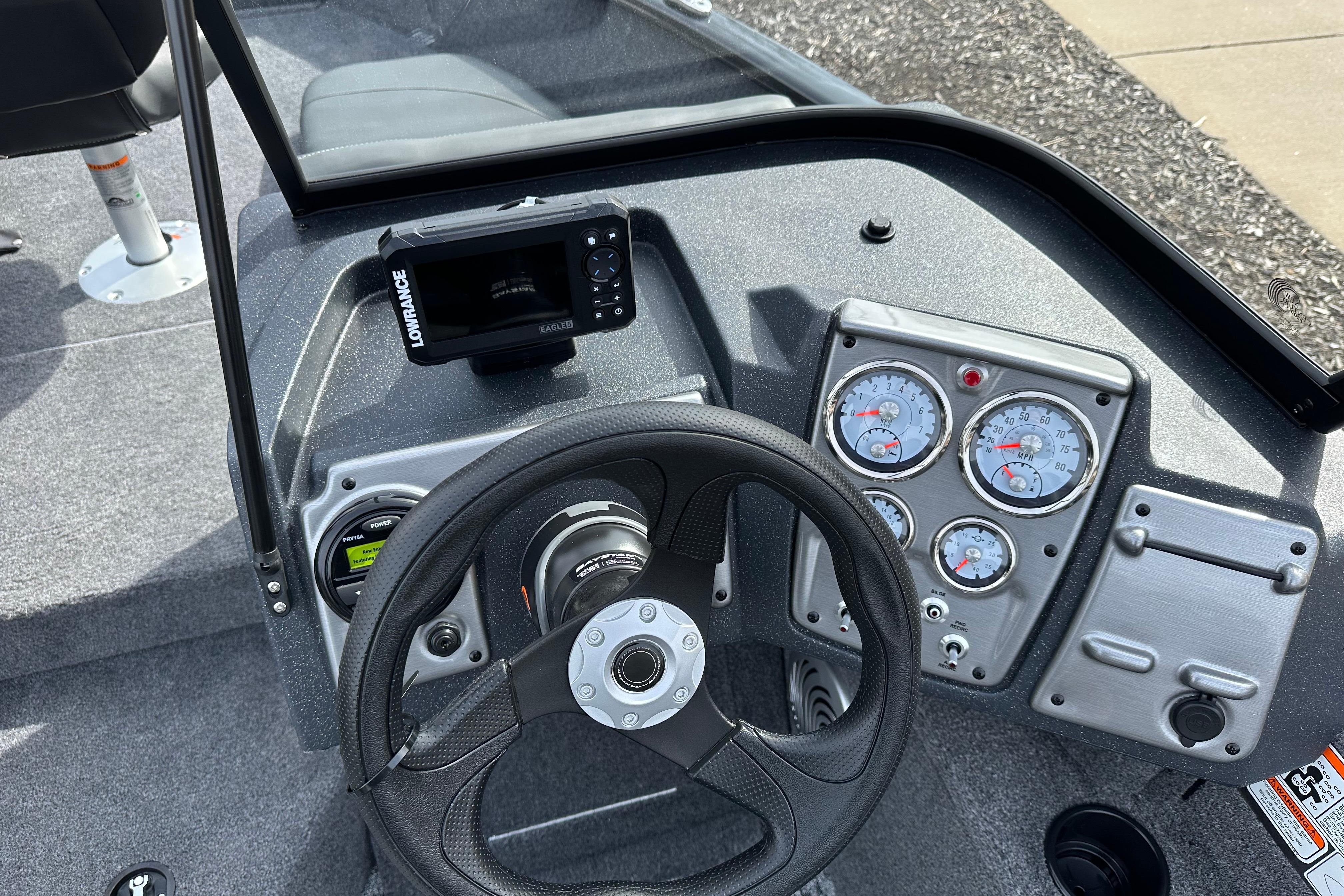 2026 Tracker Pro Guide V-175 Combo boat dashboard with steering wheel and gauges.