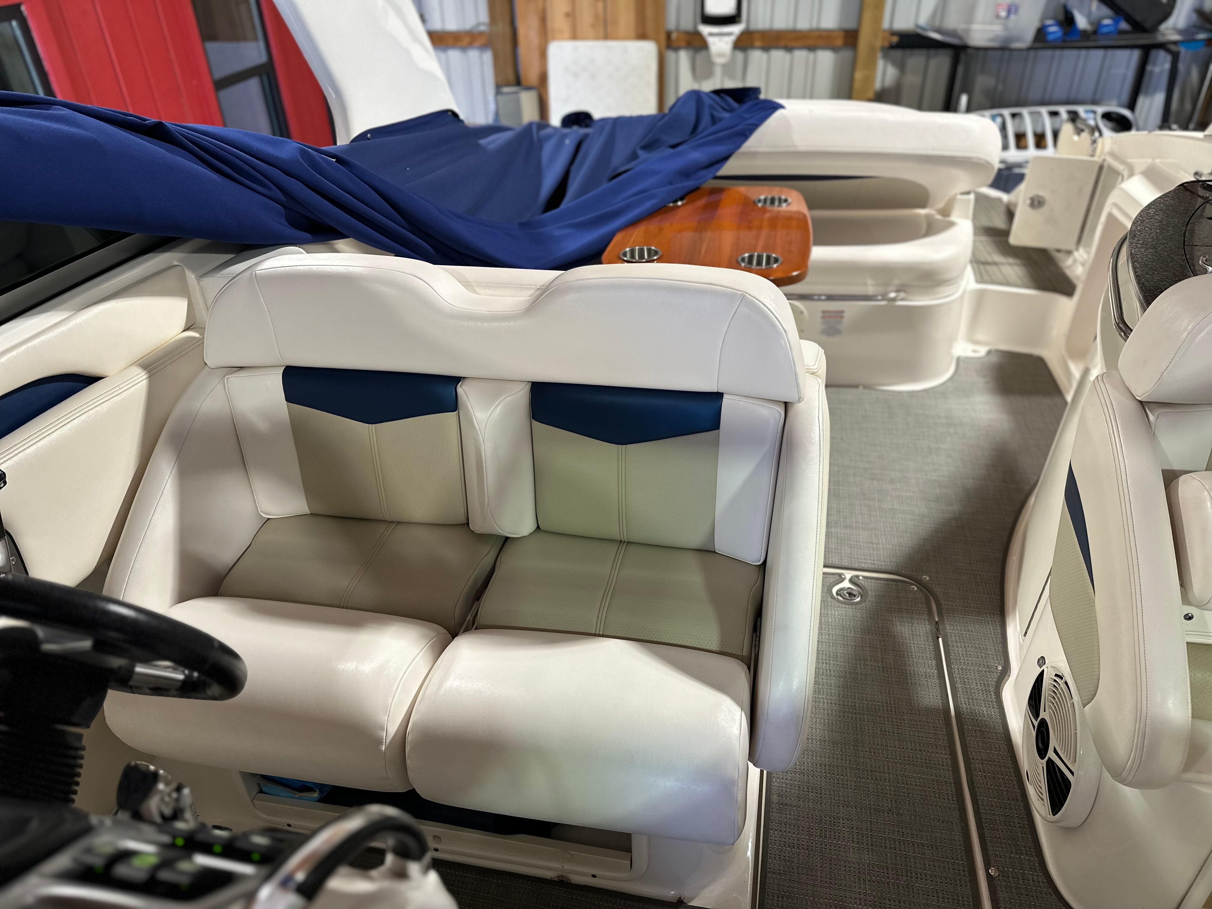 Interior of a 2011 Chaparral 287 SSX with white leather seats and blue accents.