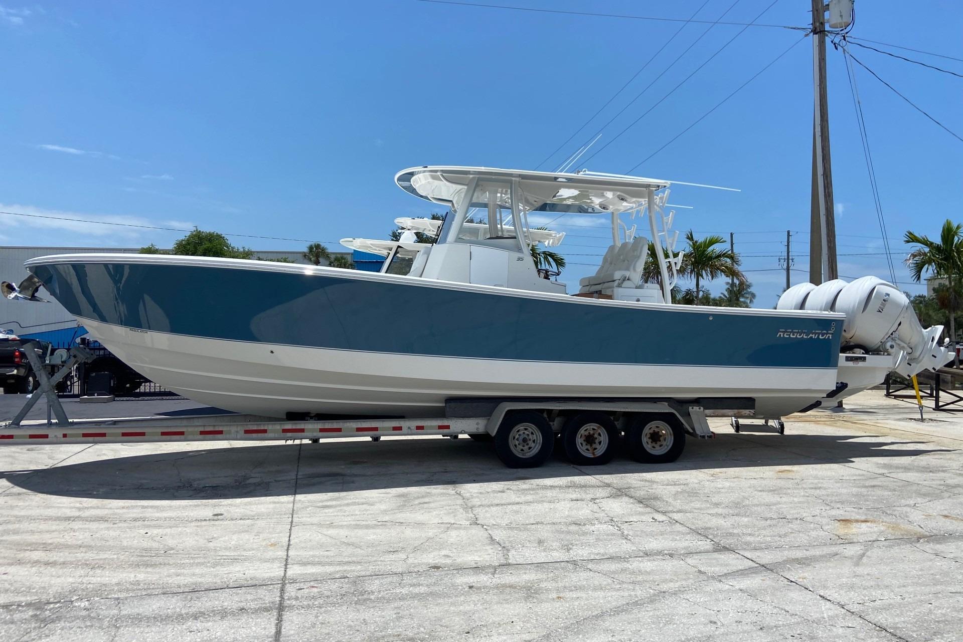 2027 Regulator 35 boat on trailer, blue and white design, parked outdoors.