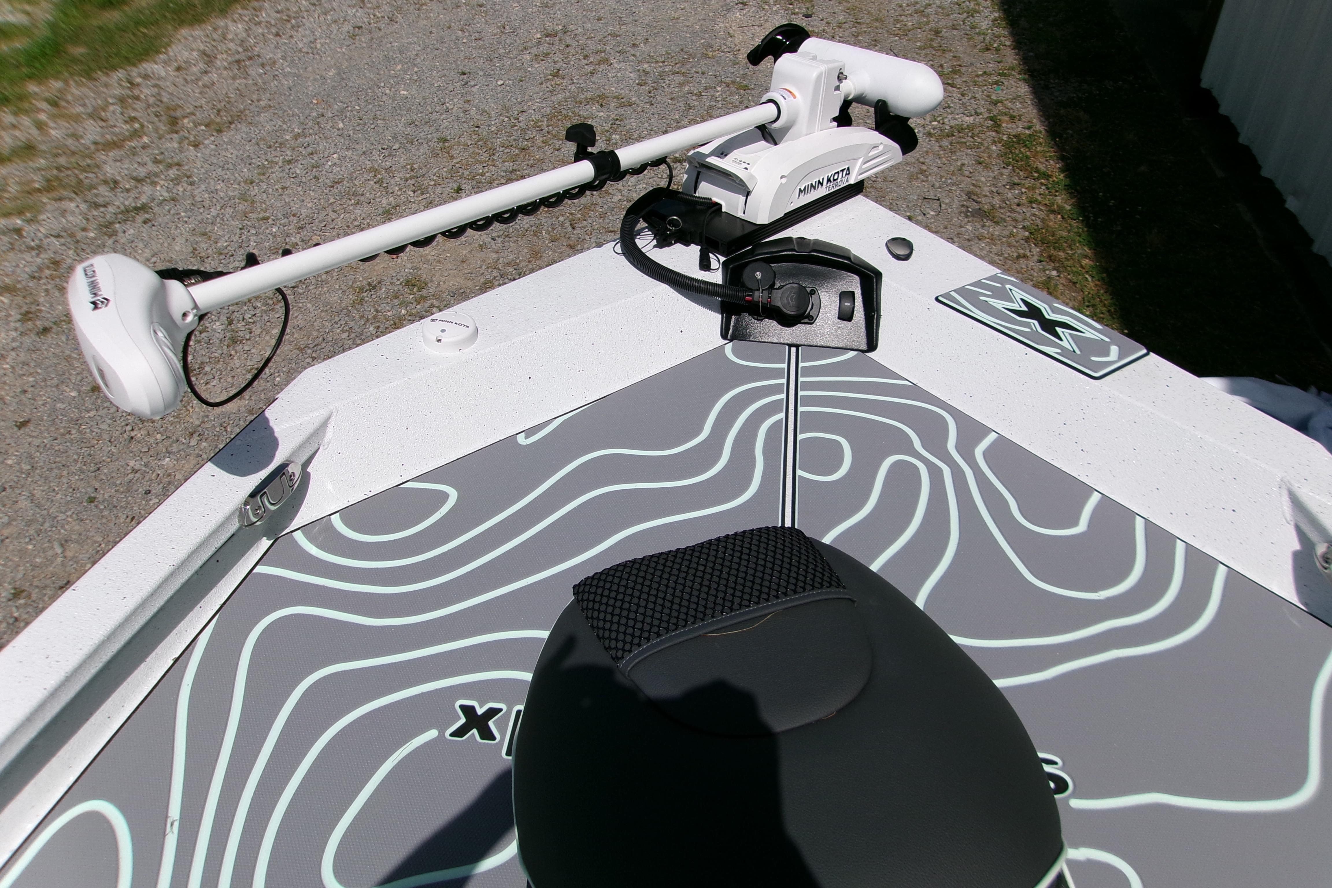 2027 Xpress H22B Bay boat with Minn Kota trolling motor on deck.