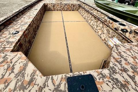 2026 Xpress X18DB boat interior with camouflage design and spacious deck.