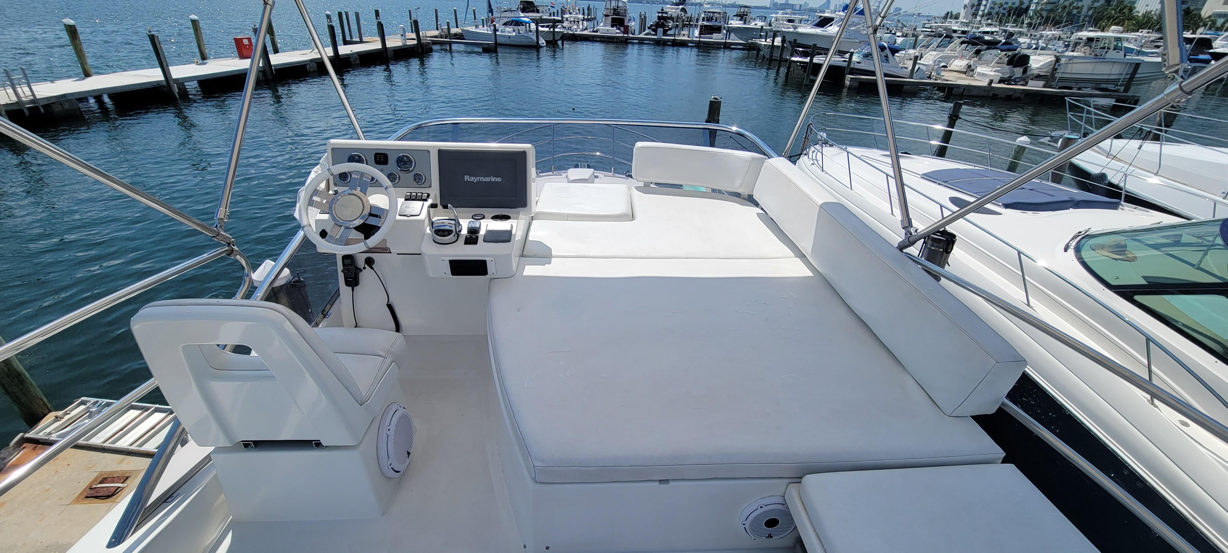 Flybridge of a 2013 Azimut 45 yacht with helm station and seating area.