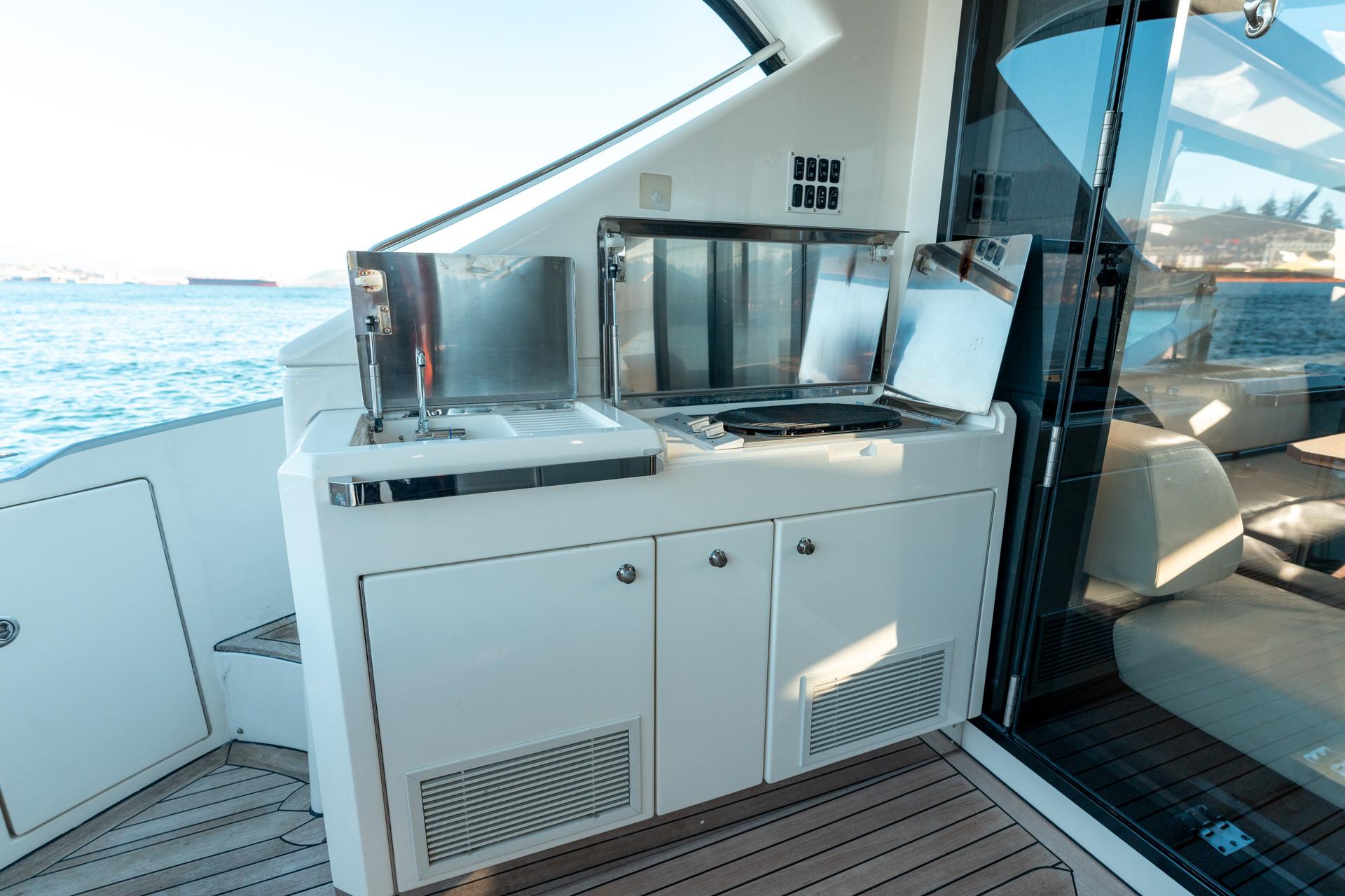 Outdoor kitchen on 2009 Marquis 500 Sport Coupe yacht with ocean view.