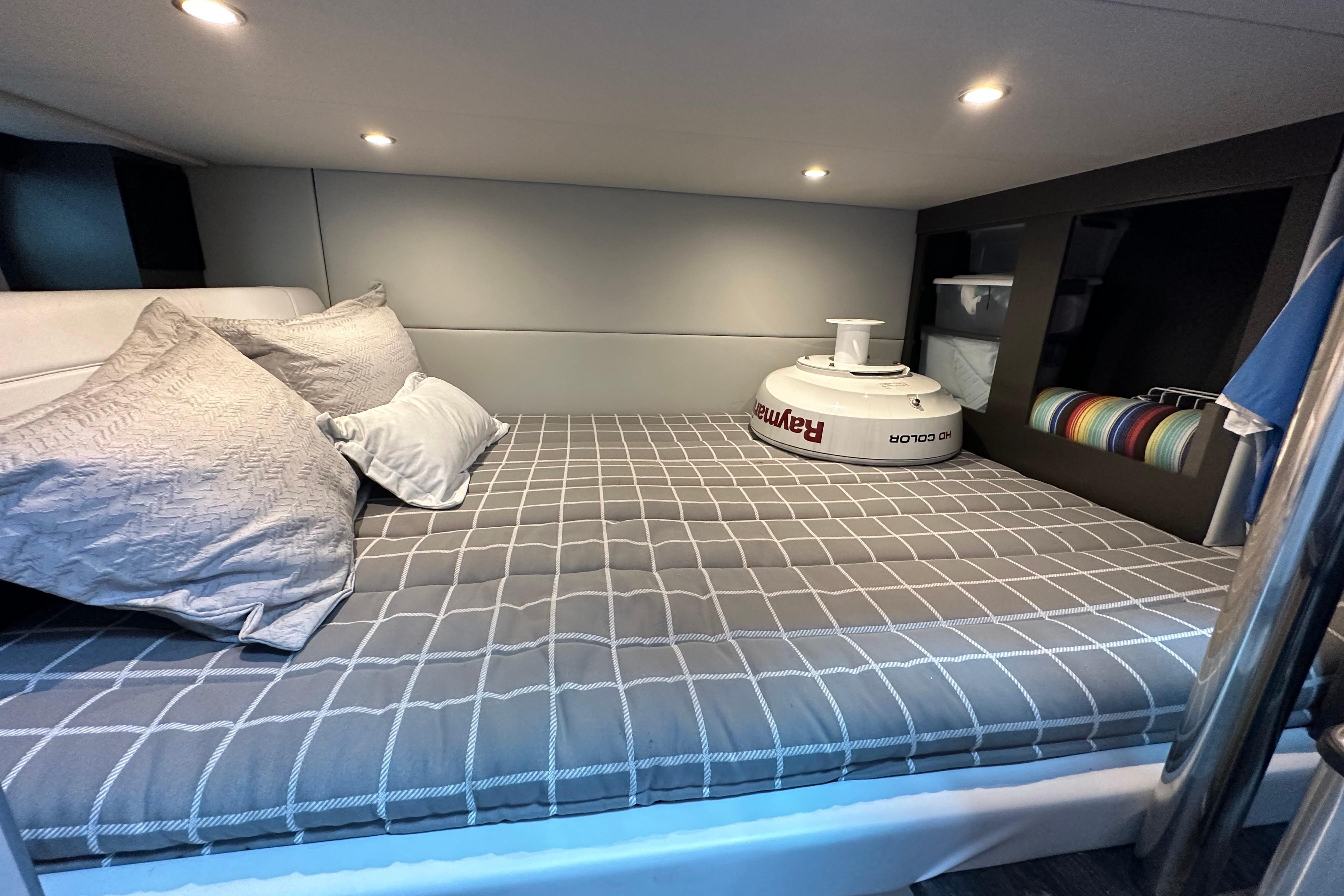Cozy cabin interior of 2021 Formula 380 Super Sport Crossover OB with plush bedding.