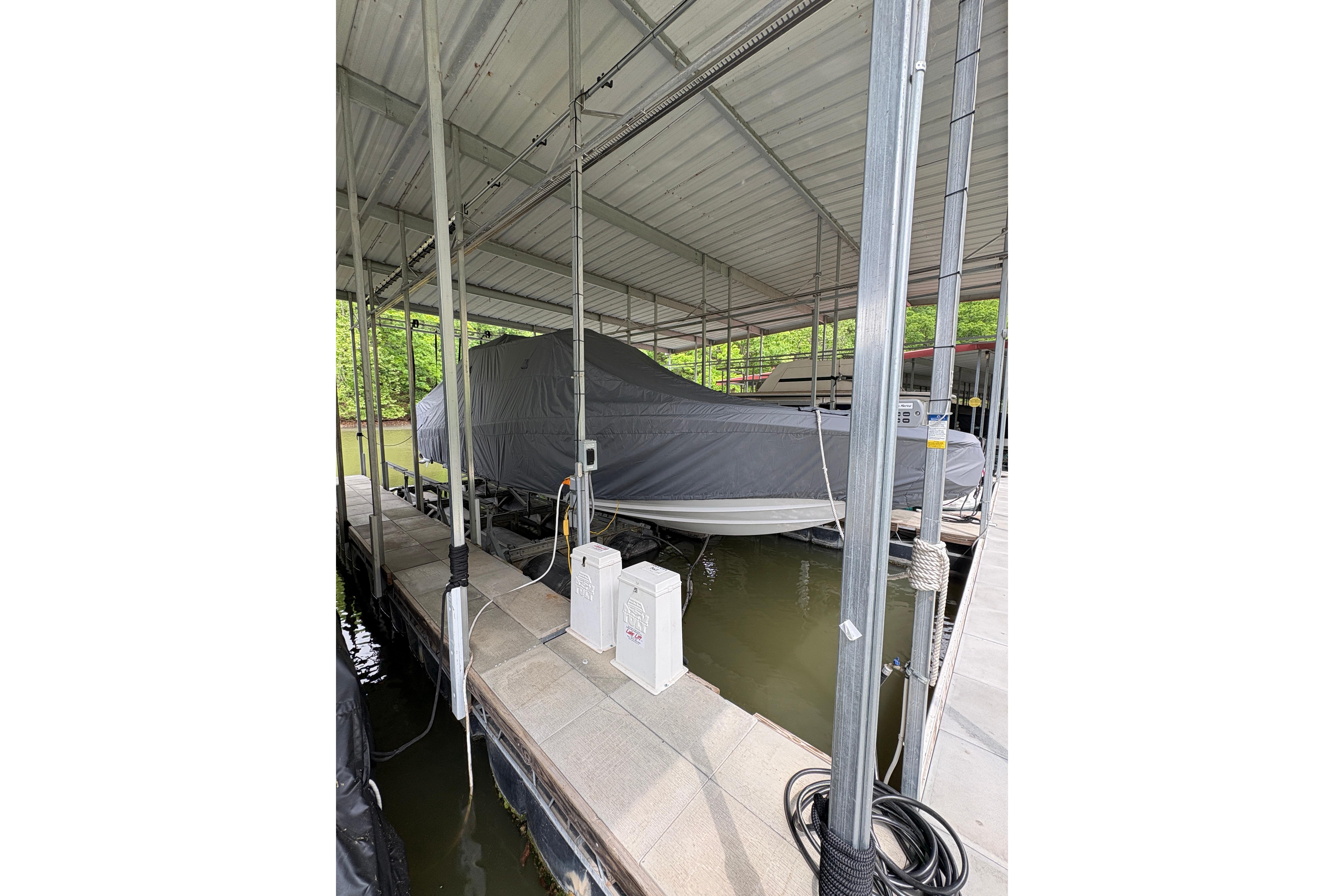 2022 Nor-Tech 392 Super Fish boat covered and docked in a marina.