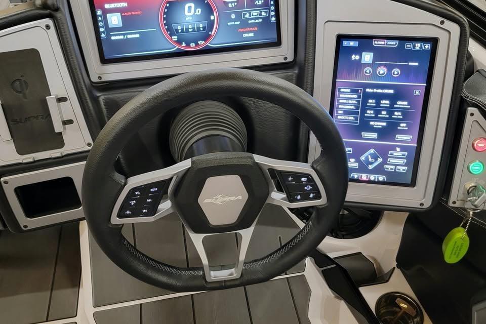 Steering wheel and dashboard of 2023 Supra SE 550 boat with digital displays.
