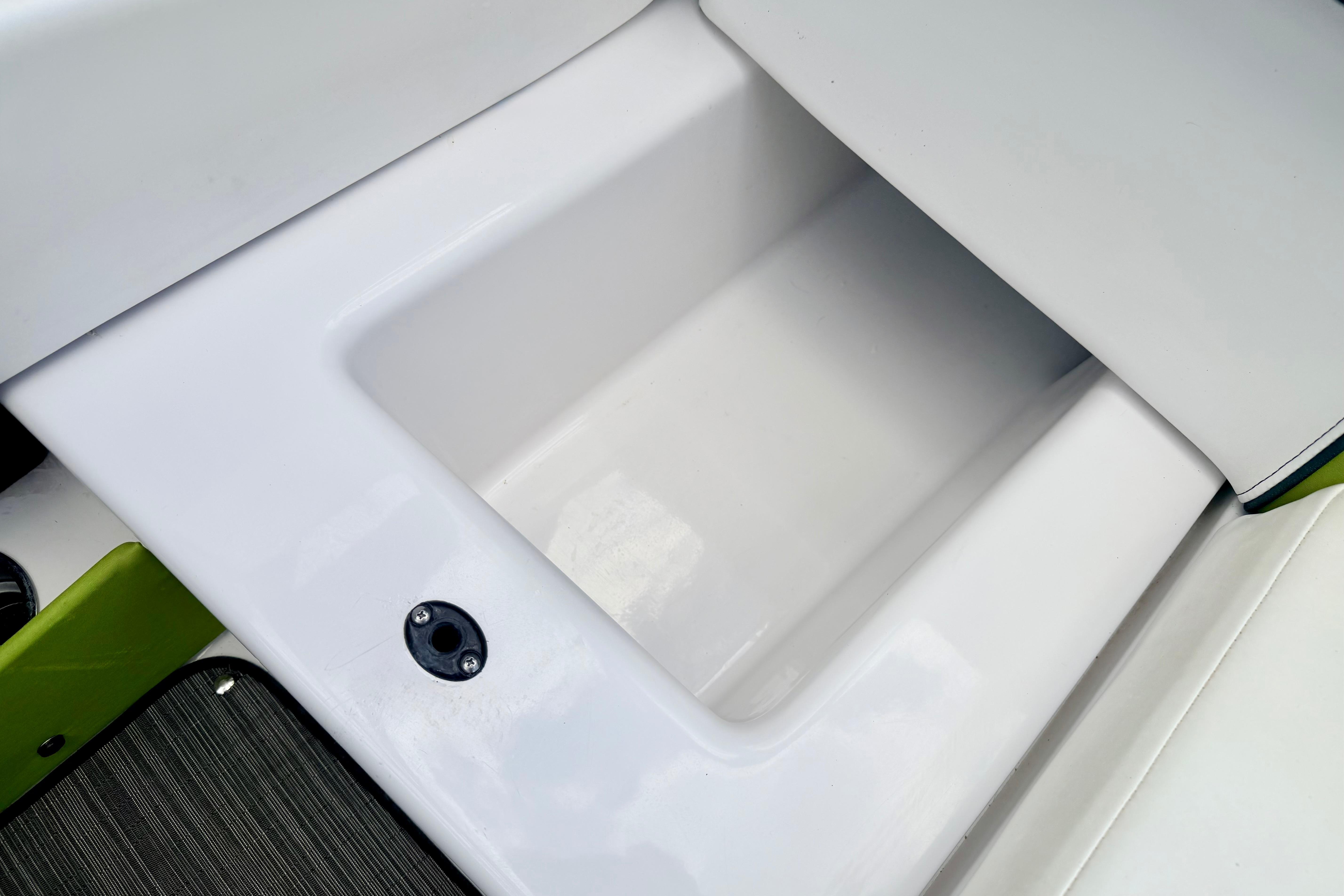 Storage compartment on a 2018 Glastron GT 185 boat, featuring sleek white design.