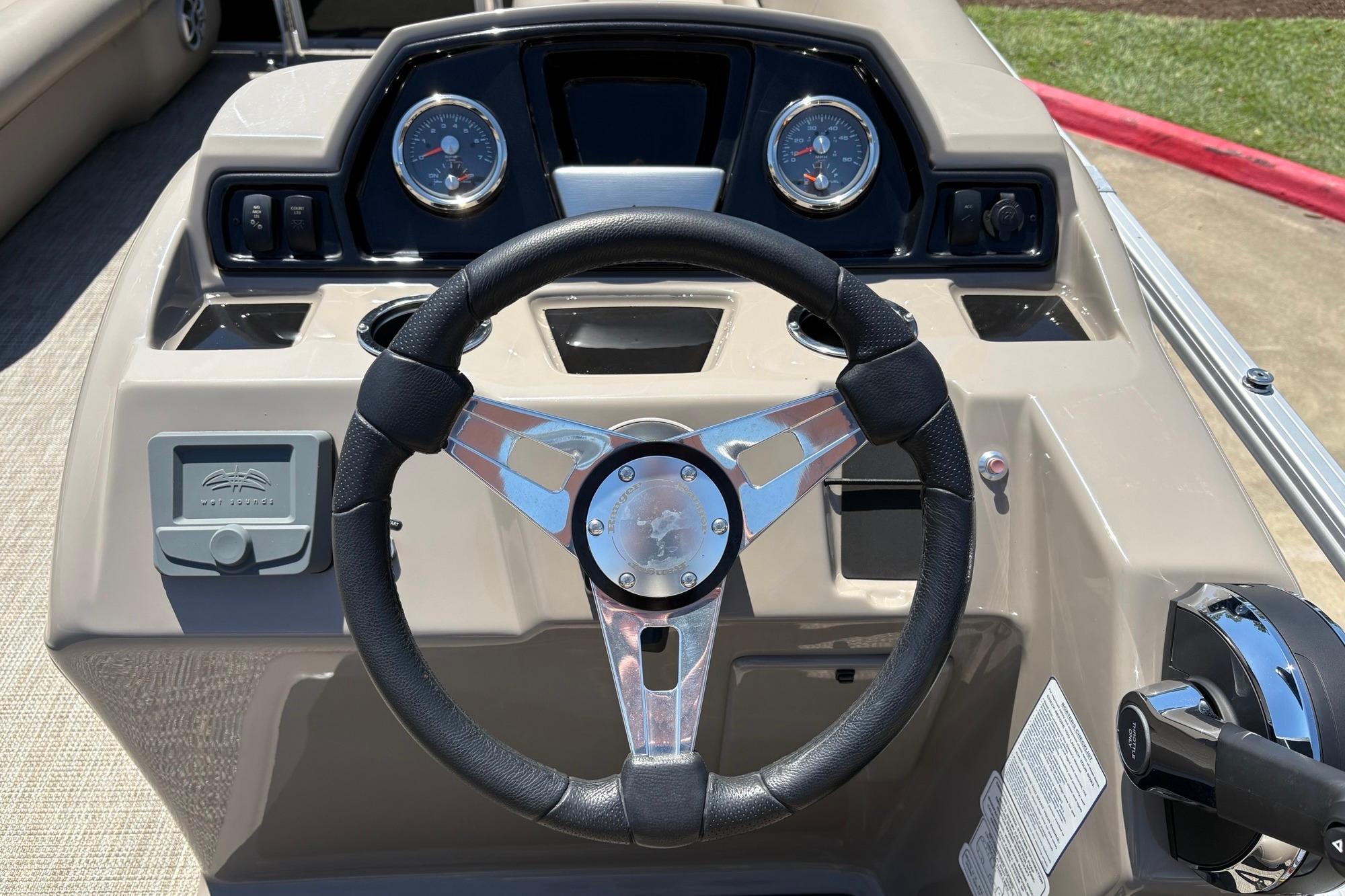 Steering console of 2024 Ranger Reata 200C boat with gauges and controls.