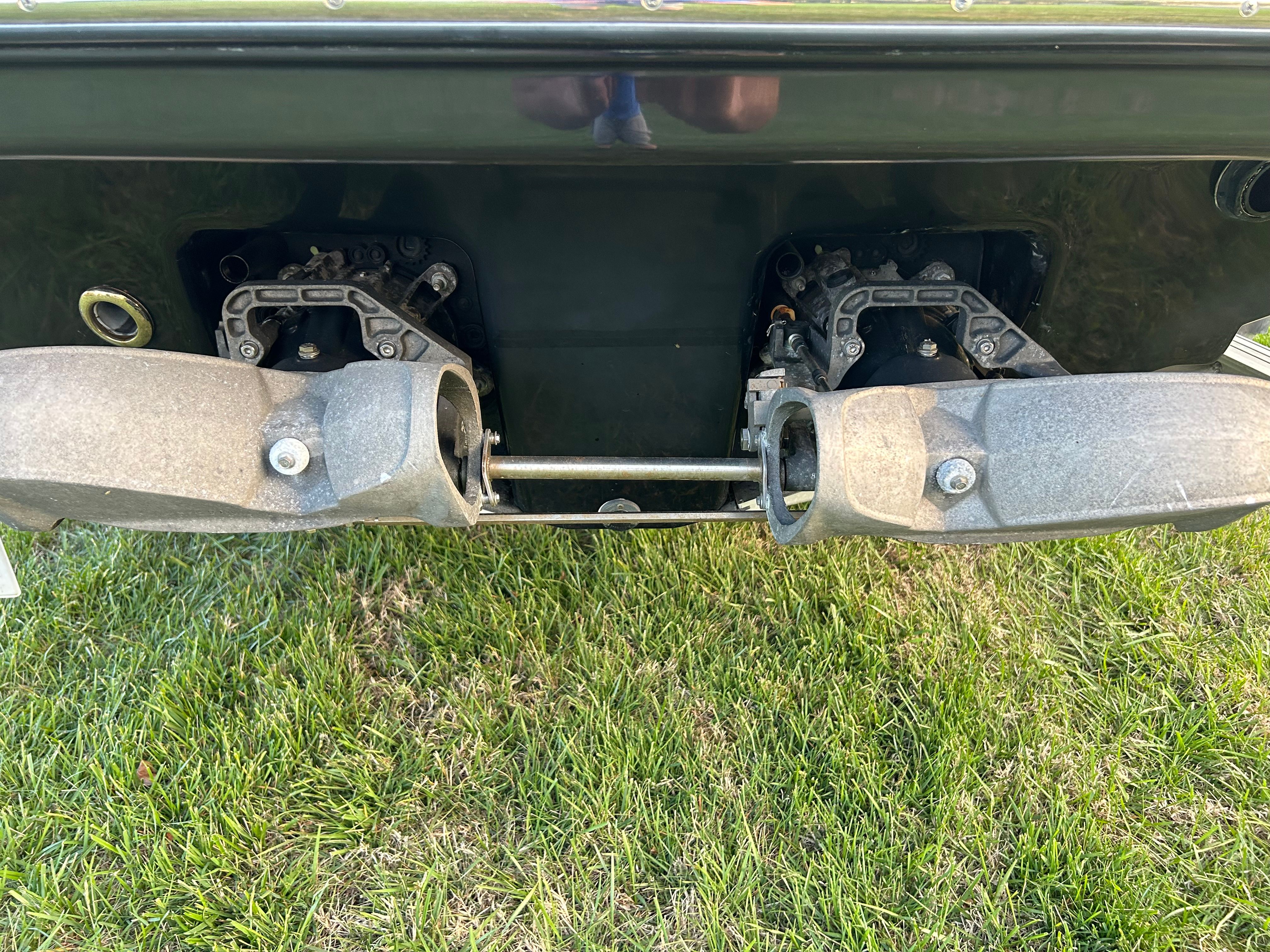 Rear view of a 2015 Chaparral Vortex 243 VRX boat on grass.