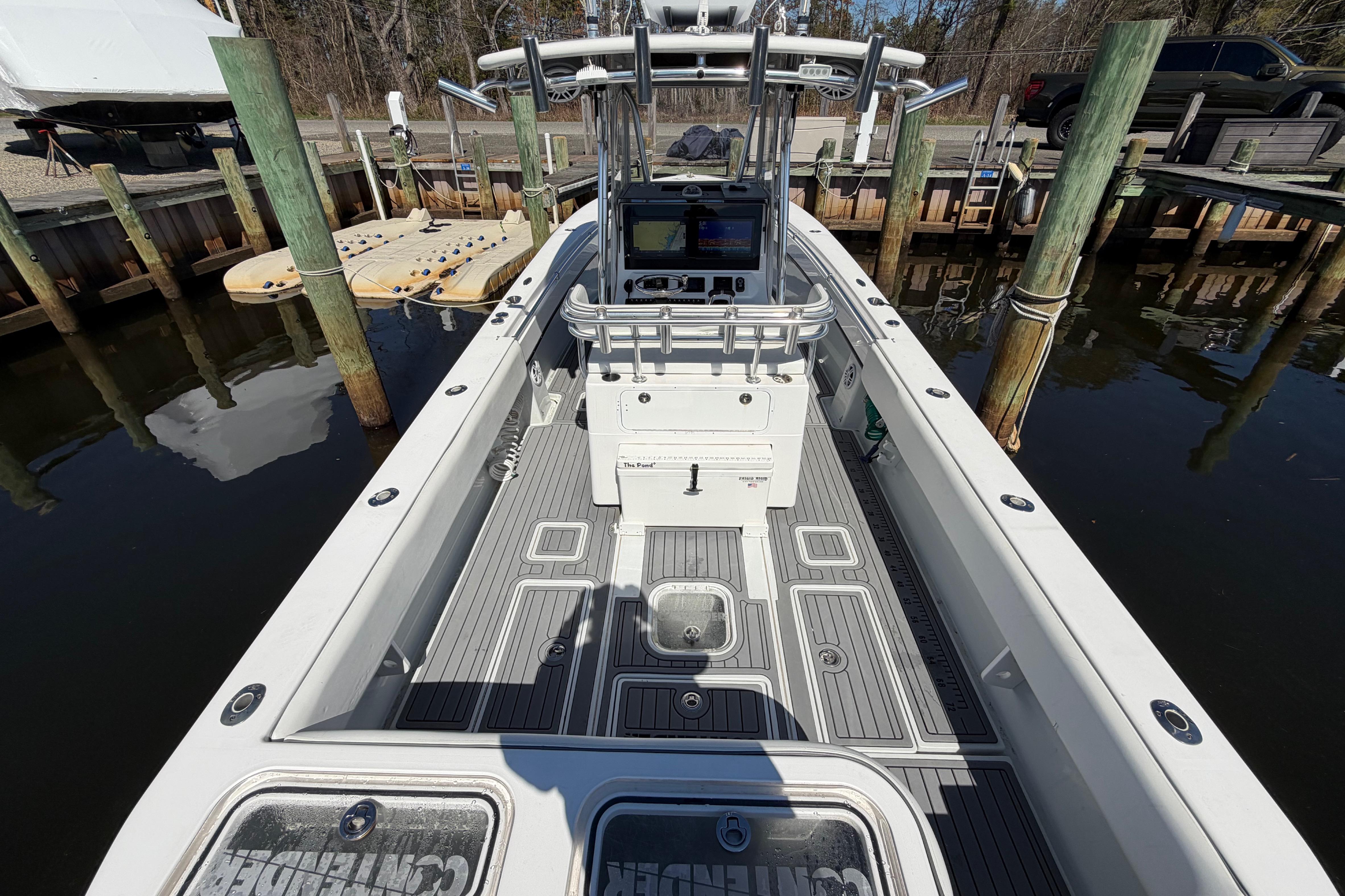 2015 Contender 32 ST boat docked, showcasing spacious deck and modern console.