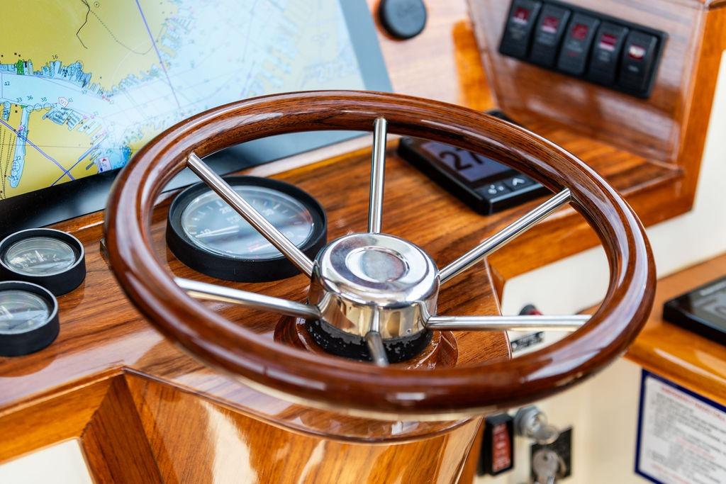 Steering wheel and dashboard of 2002 Hinckley Picnic Boat 36 EP.