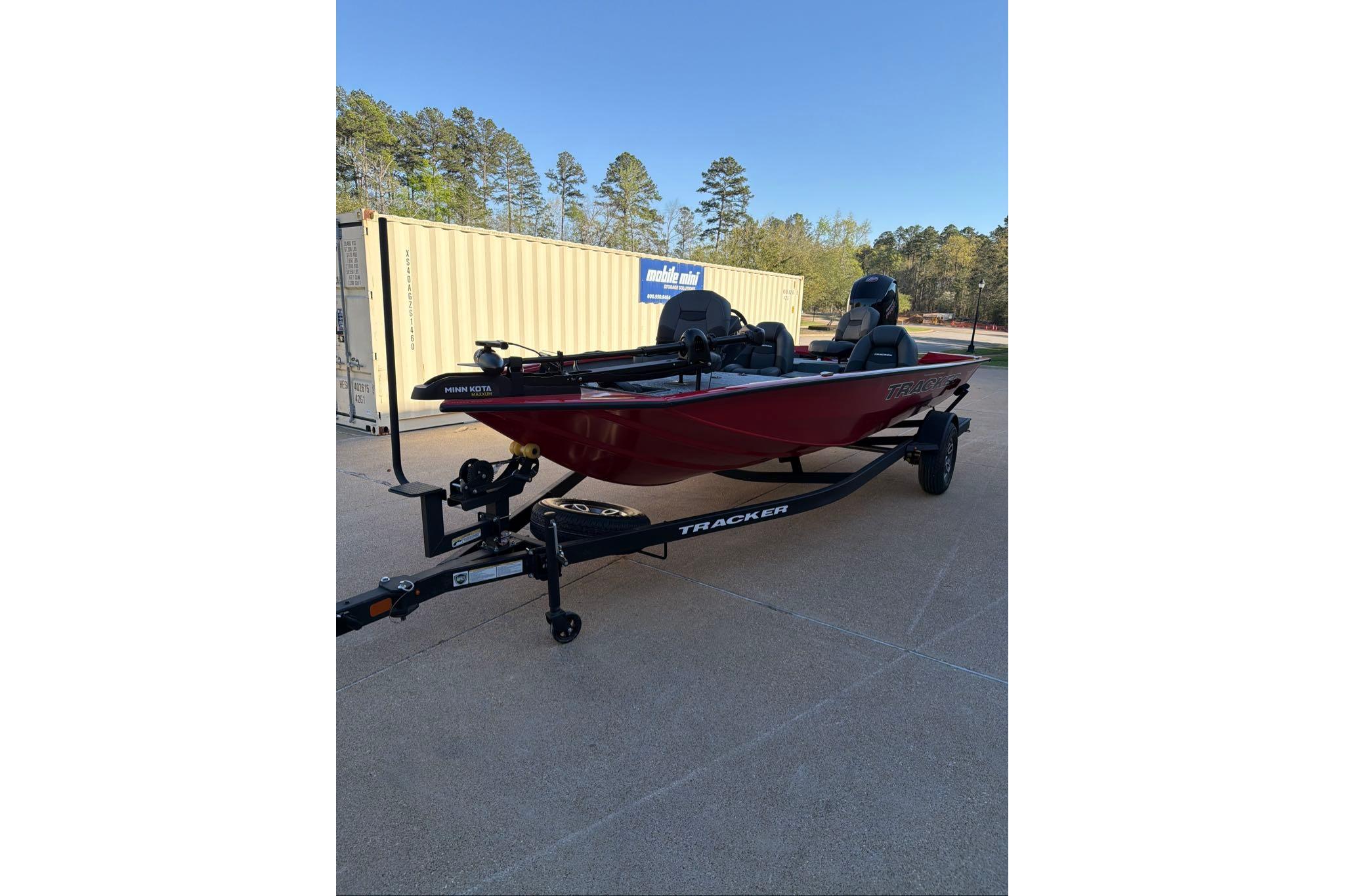 2026 Tracker Pro Team 195 boat on trailer, parked outdoors.