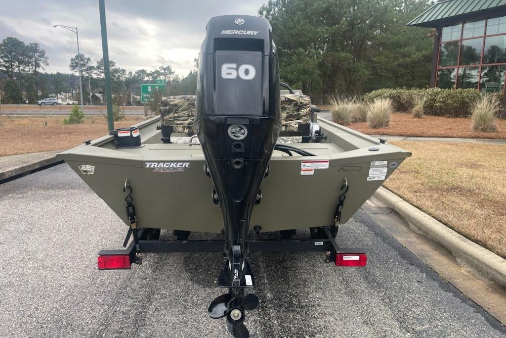 2026 Tracker Grizzly 1754 SC boat with Mercury 60 engine, parked outdoors.