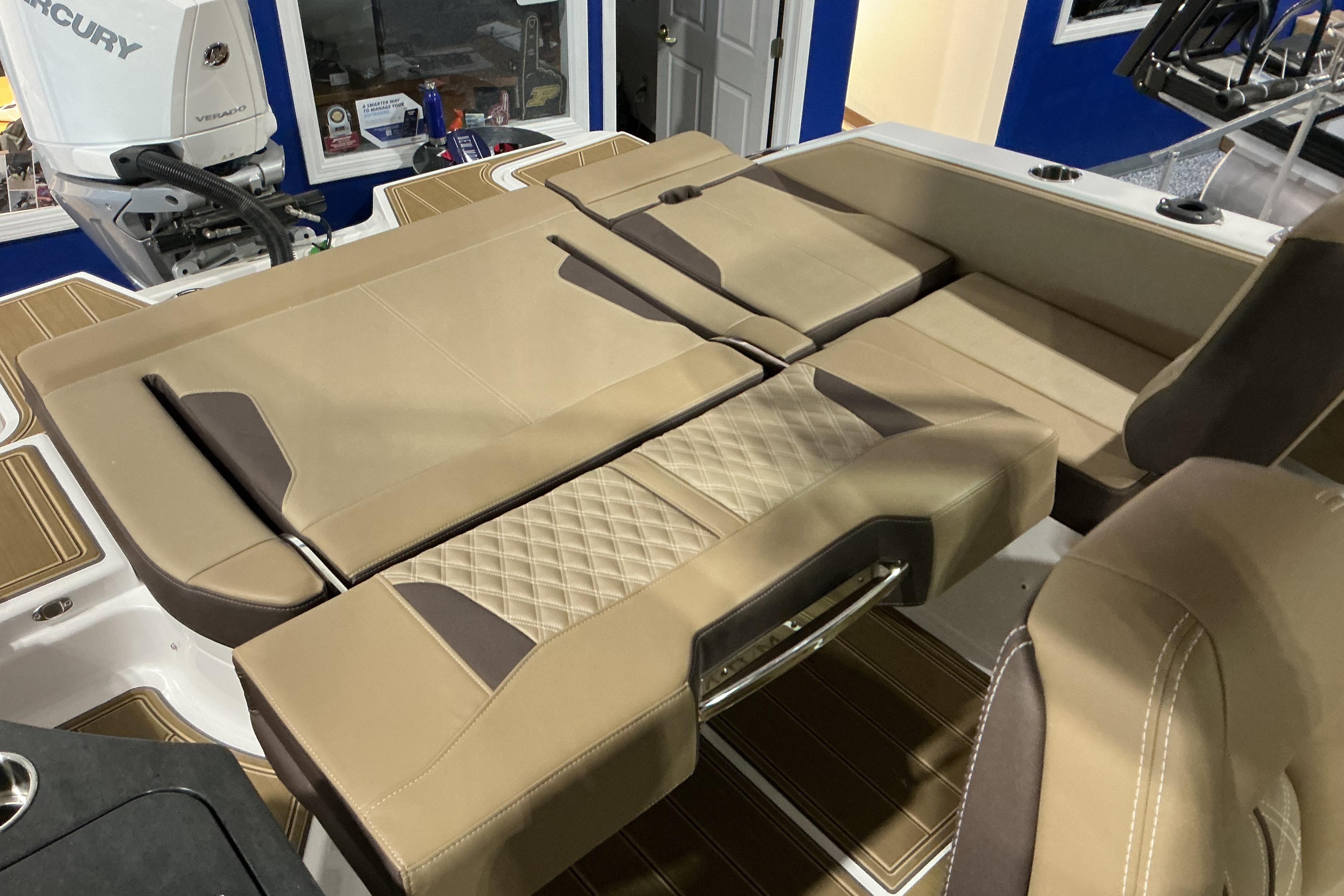 Luxurious seating on 2026 Monterey Elite 25 OB boat, featuring tan upholstery and modern design.