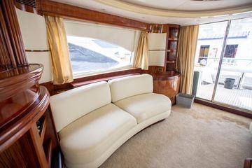 Luxurious interior of 2003 Azimut 74 Solar yacht with elegant seating and large windows.