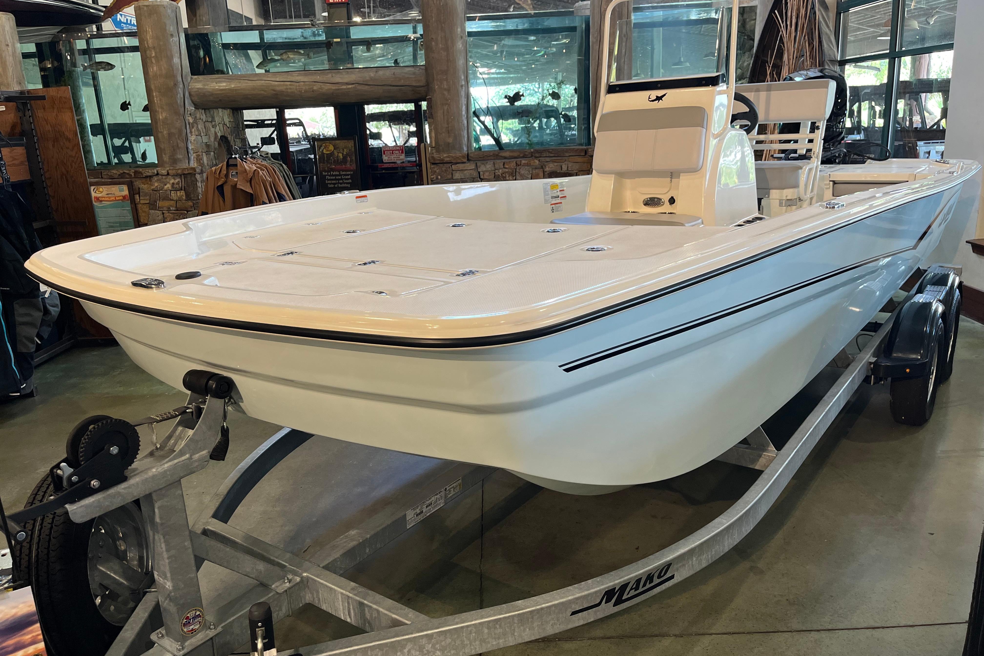 2024 Mako Pro Skiff 19 CC boat displayed indoors on a trailer.