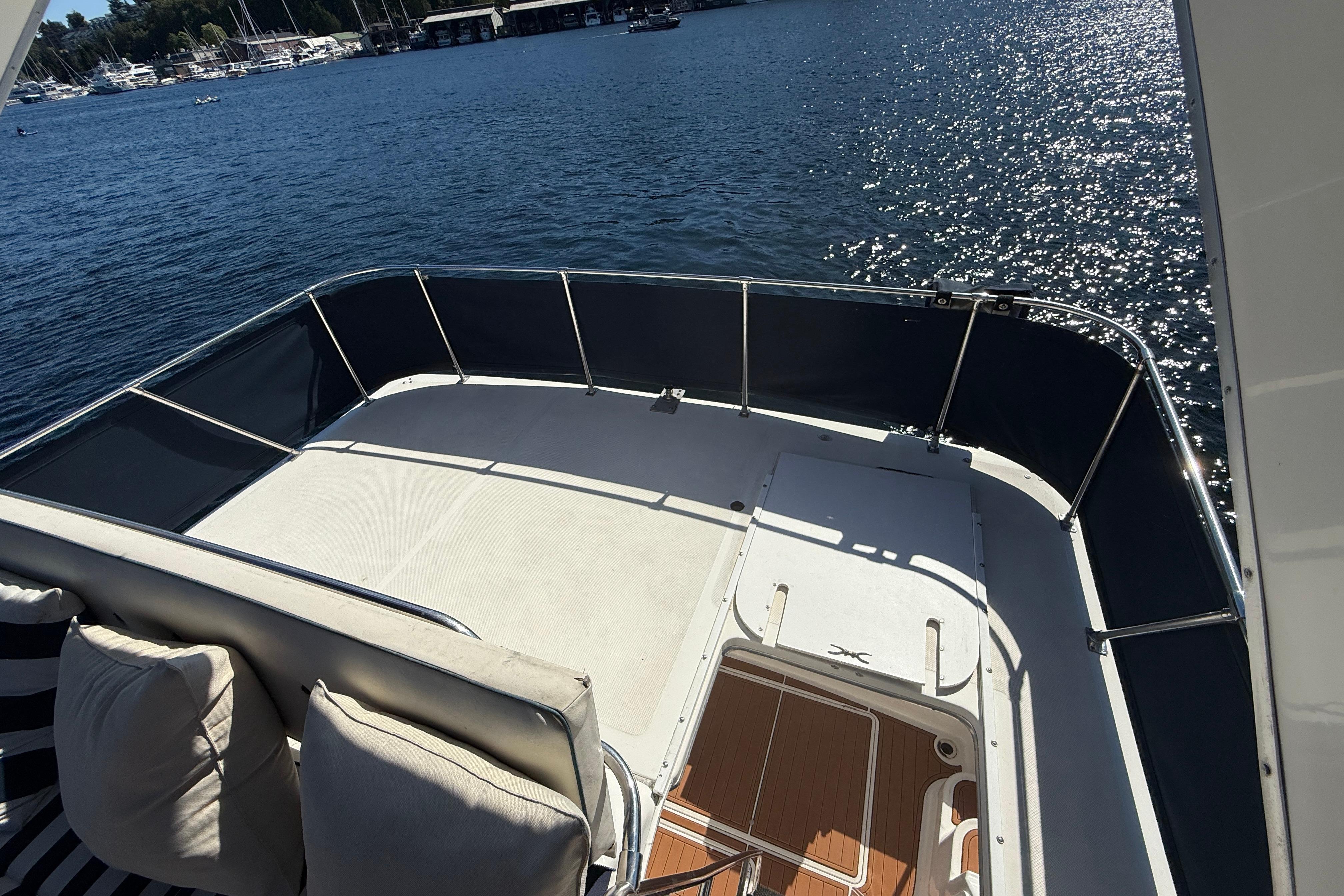 1997 Bayliner 3988 Command Bridge Motoryacht deck overlooking serene marina waters.