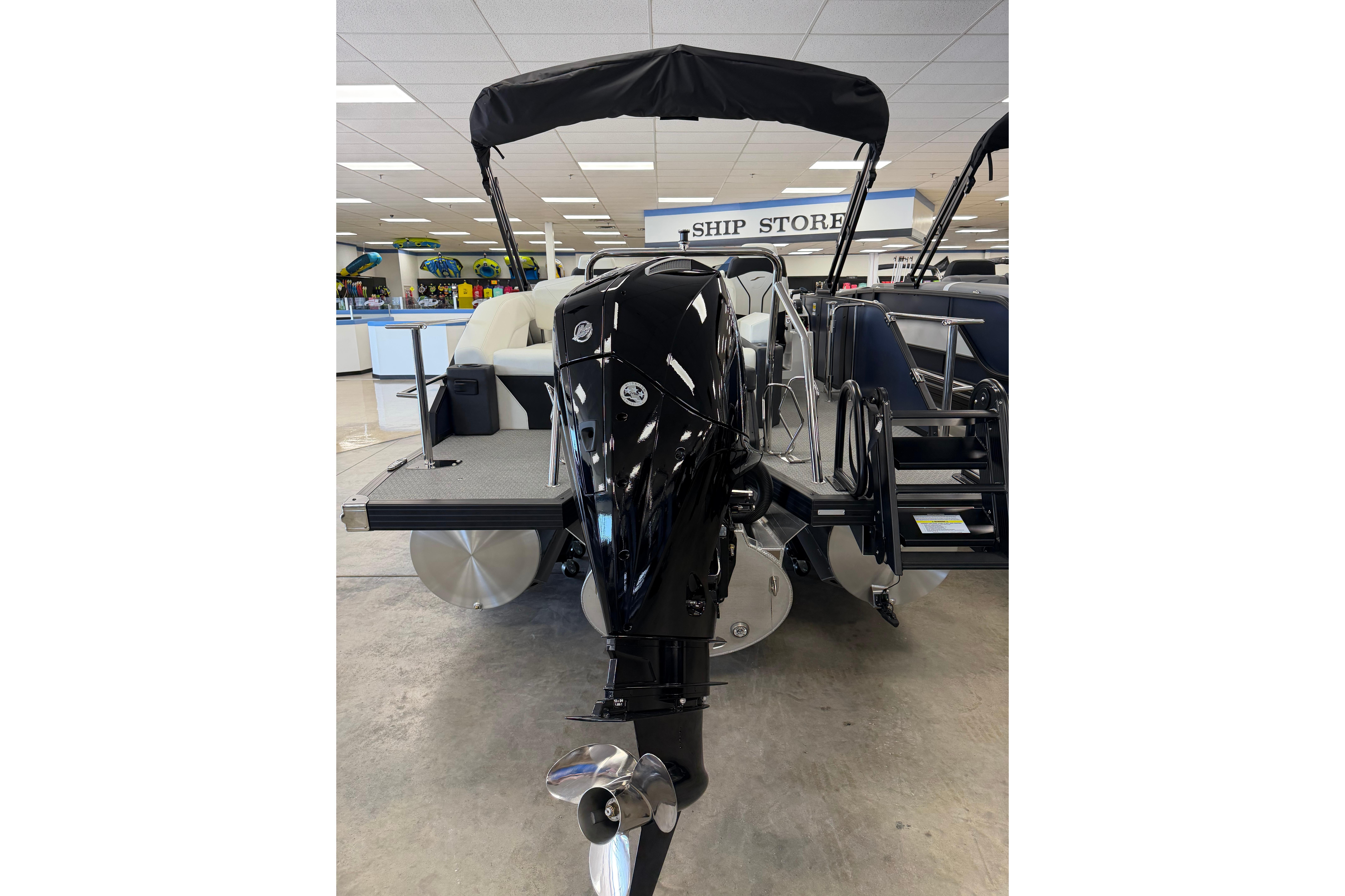 2026 Evotti 721CS boat with sleek black motor in showroom setting.