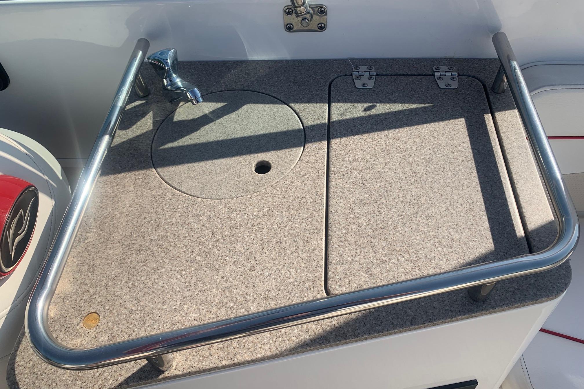 2006 Rinker 282 Captiva Cuddy boat sink with stainless steel rail and faucet.